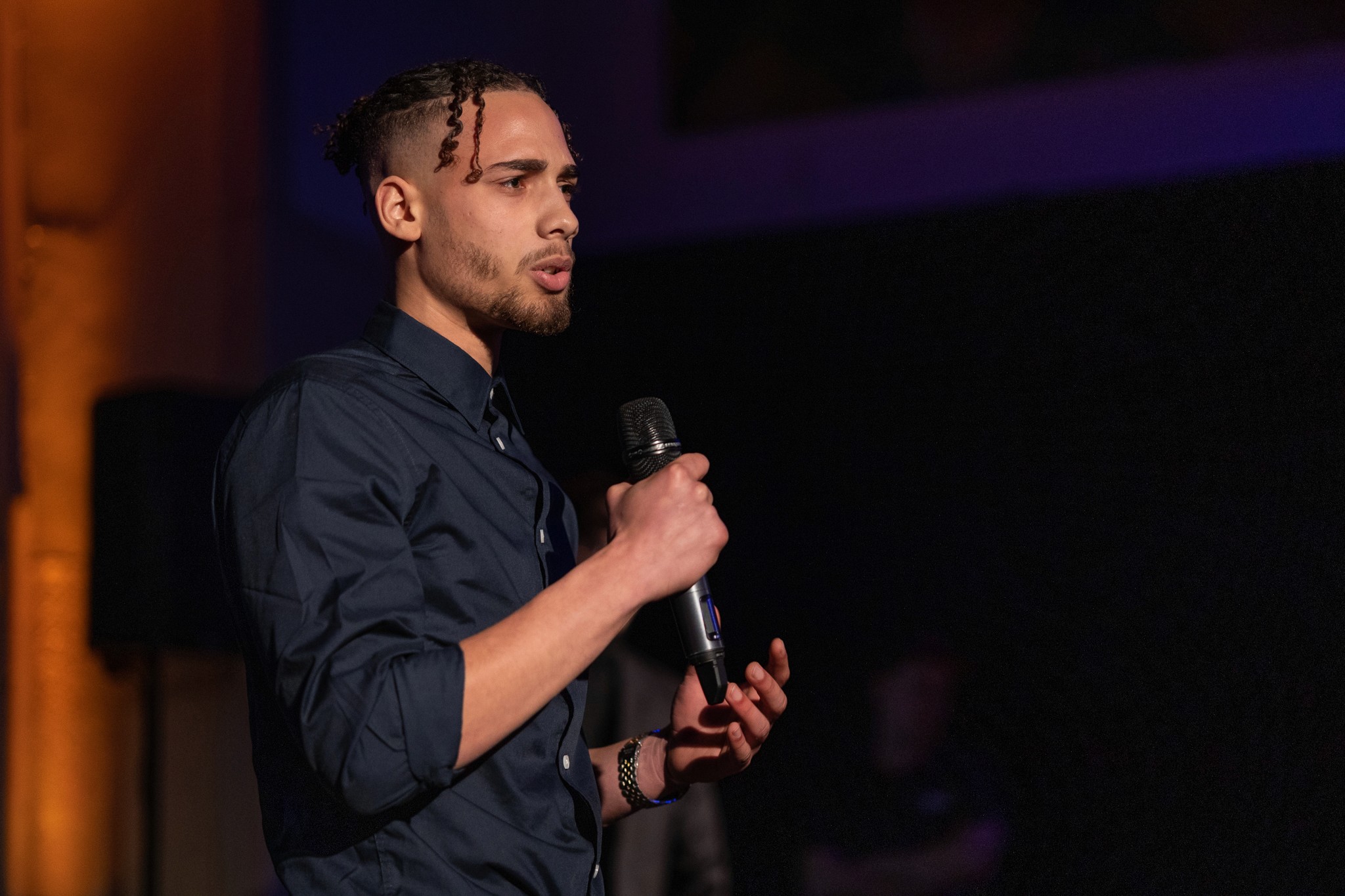 Black and white portrait of a smiling person with curly hair