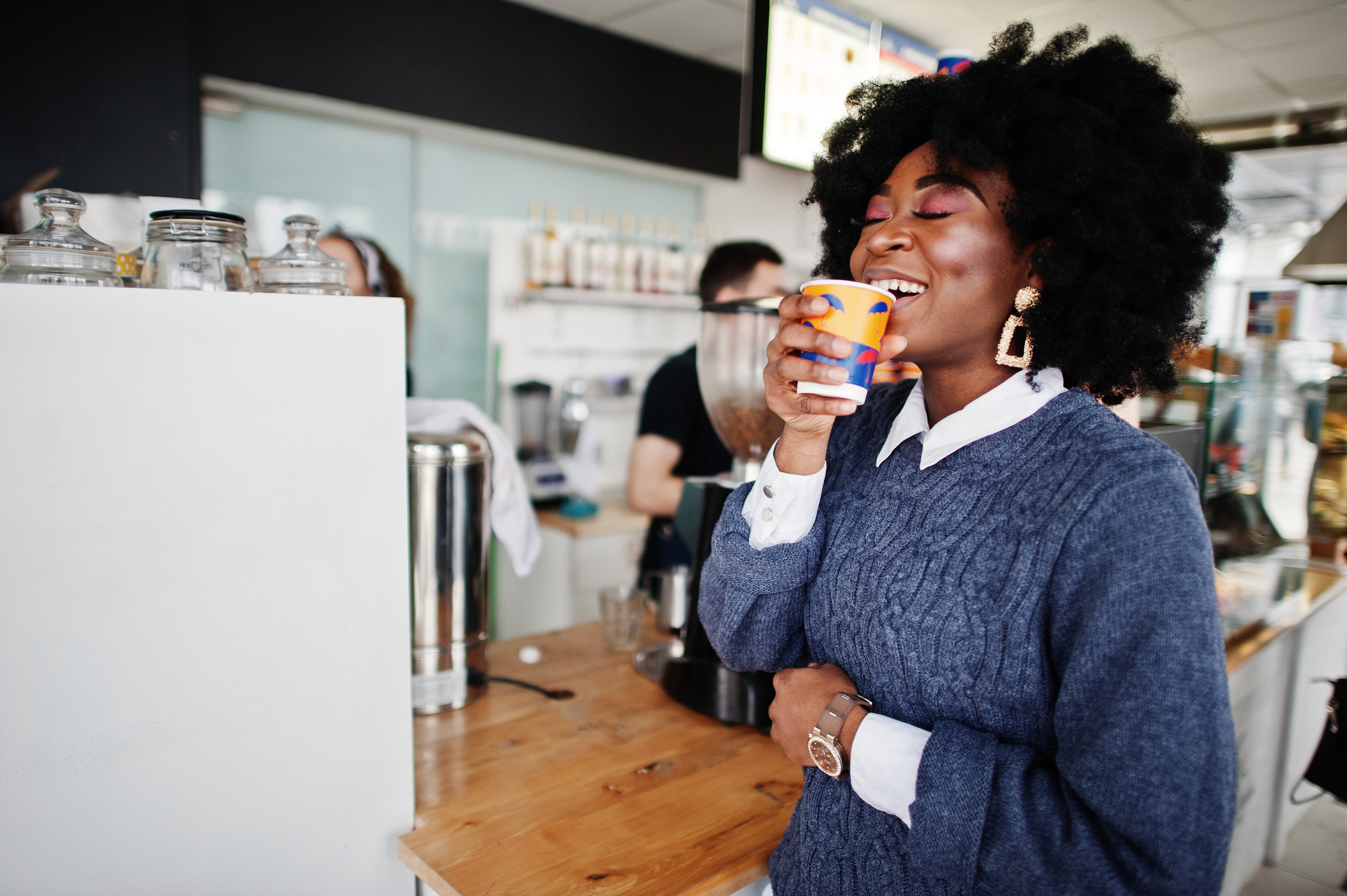 Close-up of a dark green leaf showing its textured surface and central vein against a muted background.