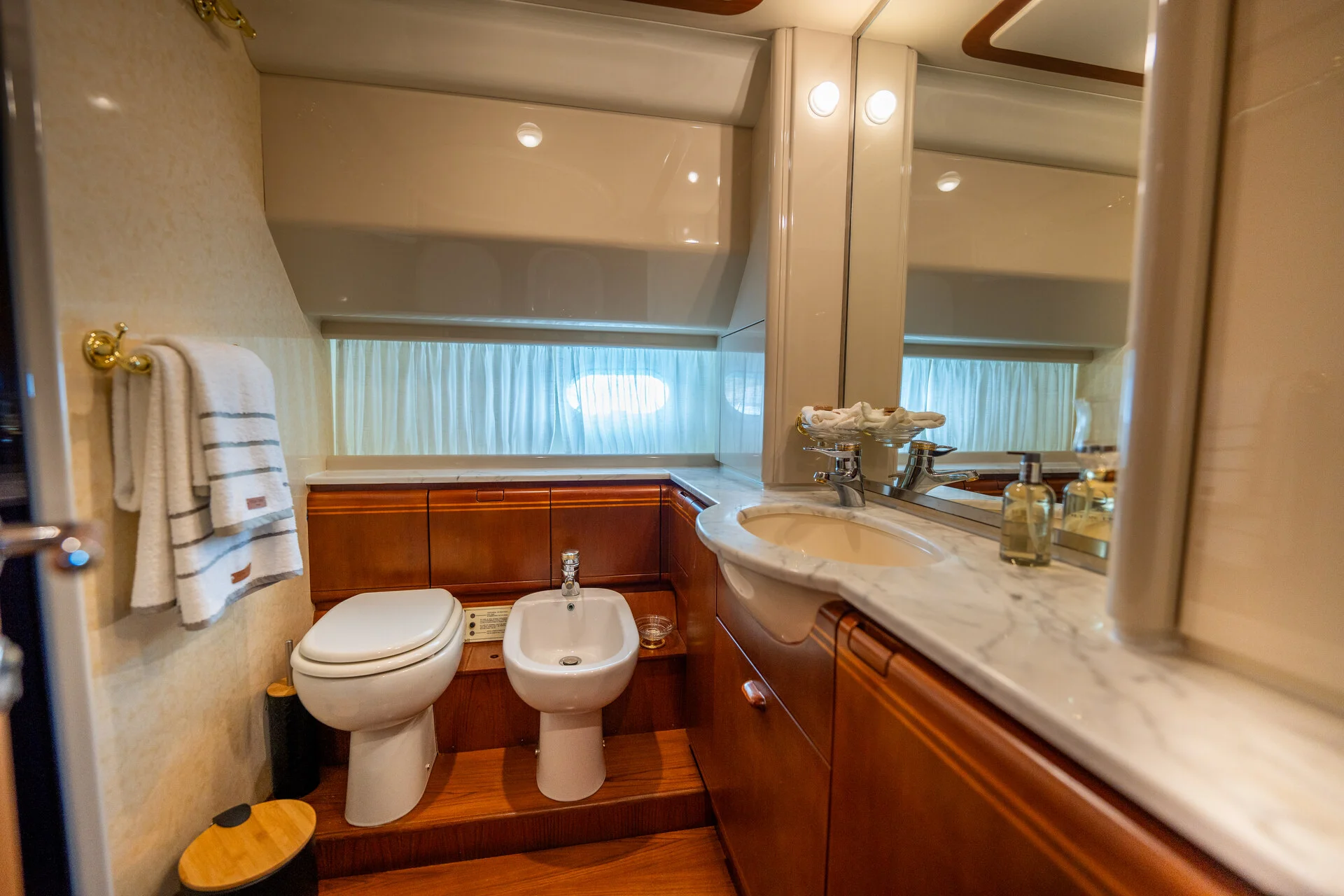 White Rock 36 speedboat with captain at helm cruising calm blue waters near Paros coastline with hills in background.
