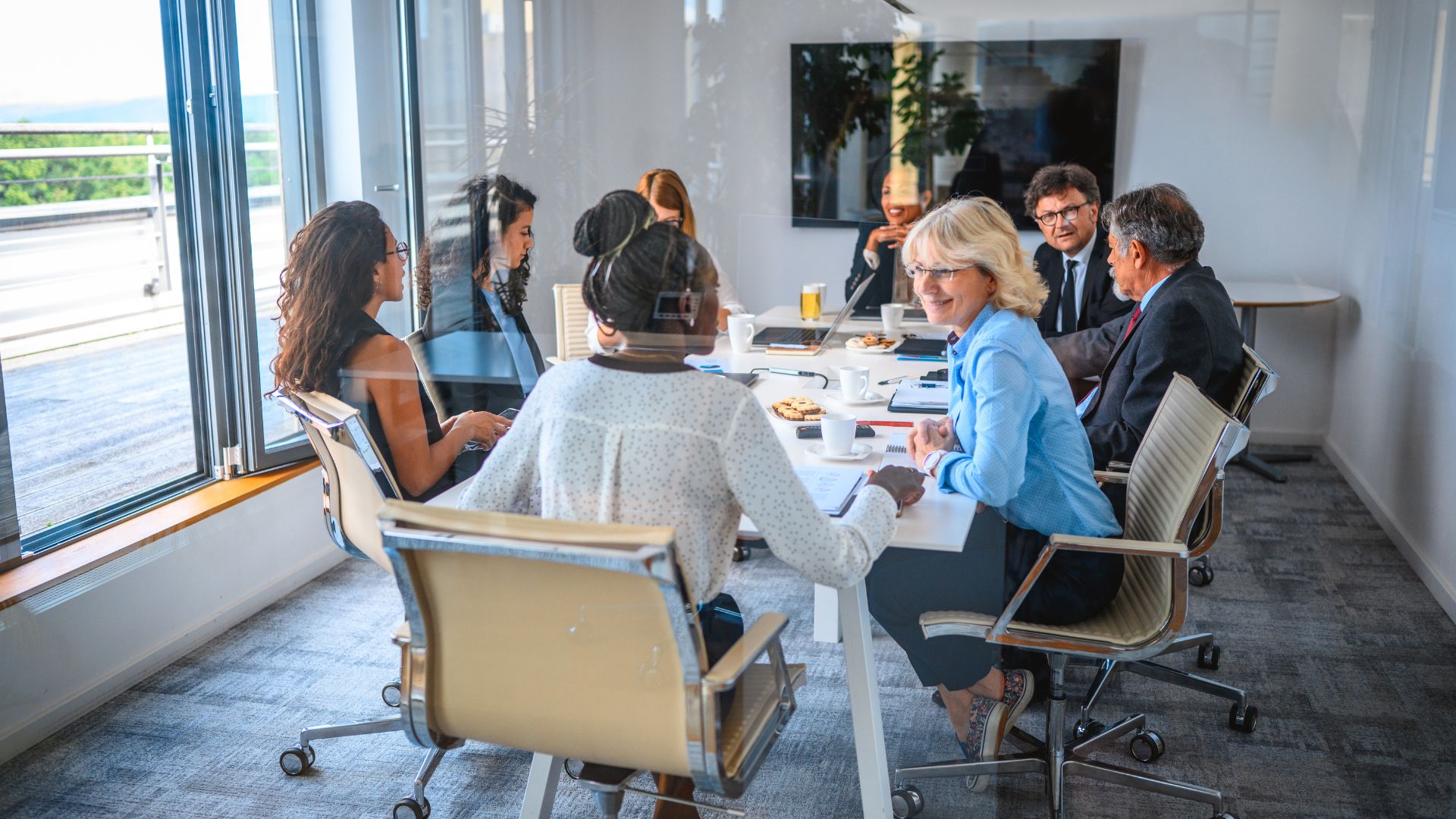 A leadership team in discussion around a meeting table