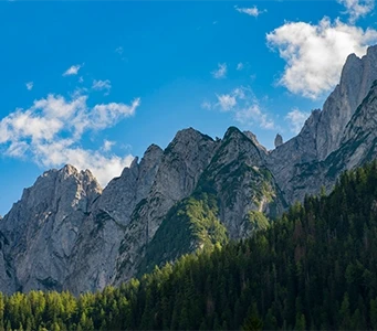 Mountain peaks under a sunny blue sky.