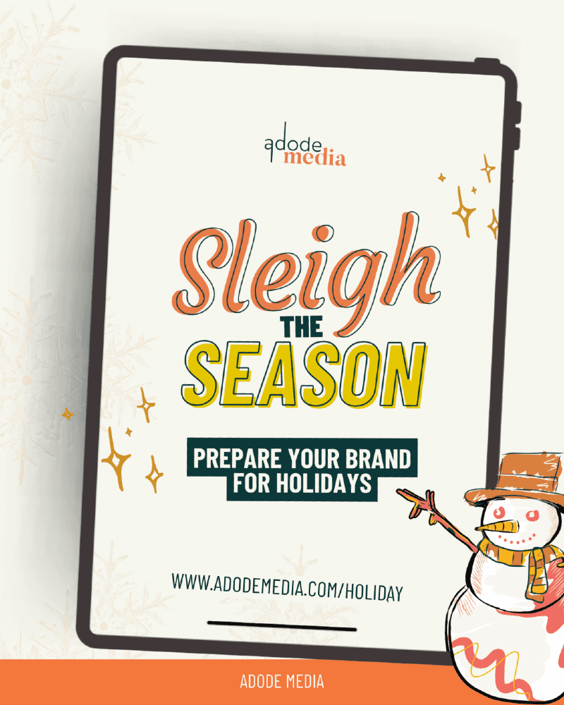 "Festive promotional graphic from Adode Media encouraging businesses to prepare their brand for the holiday season. The design features a cheerful snowman in the bottom right corner holding a candy cane, with a clipboard in the center displaying the message: 'Sleigh the Season – Prepare Your Brand for Holidays.' The website link www.adodemedia.com/holiday is included, along with a call to action at the bottom: 'Download Your Free Guide.' The overall theme uses holiday colors and playful illustrations to evoke a seasonal, marketing-focused vibe.