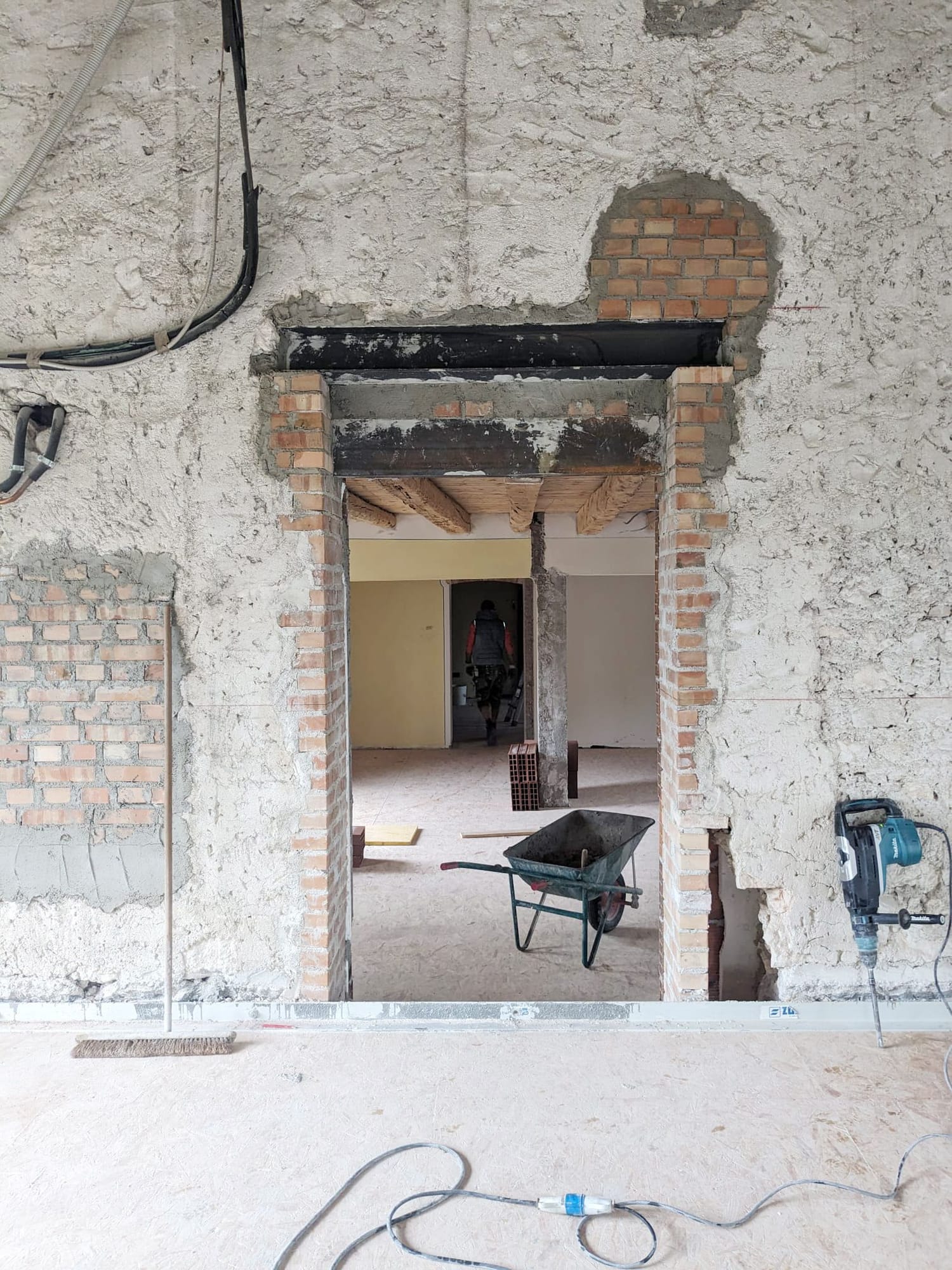 New opening cut through an old wall during the works