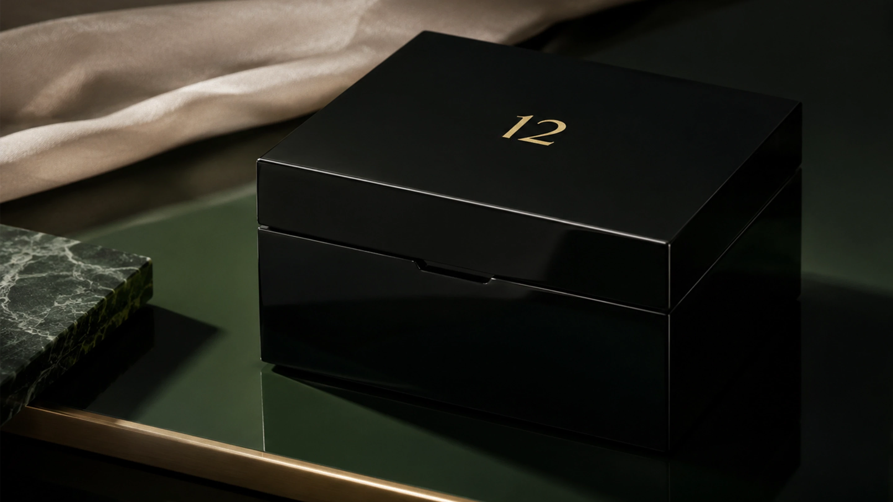 A luxury bespoke, high-gloss black lacquered luxury jewellery box with gold numbering at a master artisan workshop.