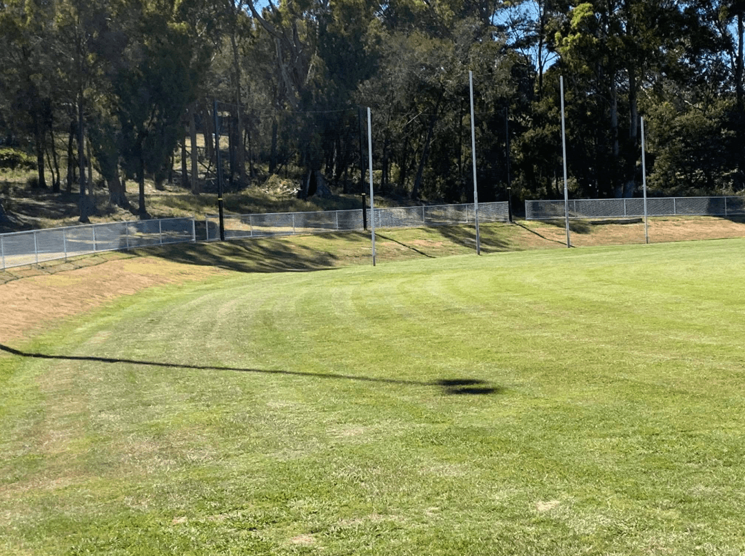 aerial photography of person trimming sports field during day