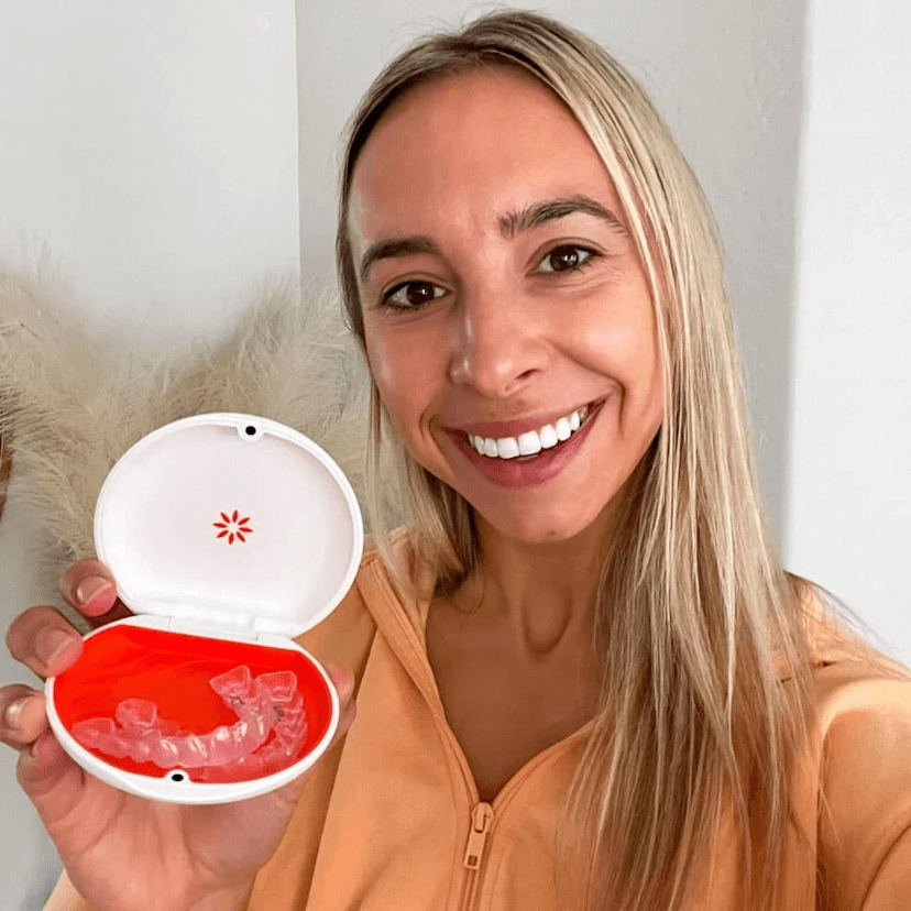 Photo of a girl holding custom Vivera retainers from Sovrle Dental Clinic in North York, Ontario