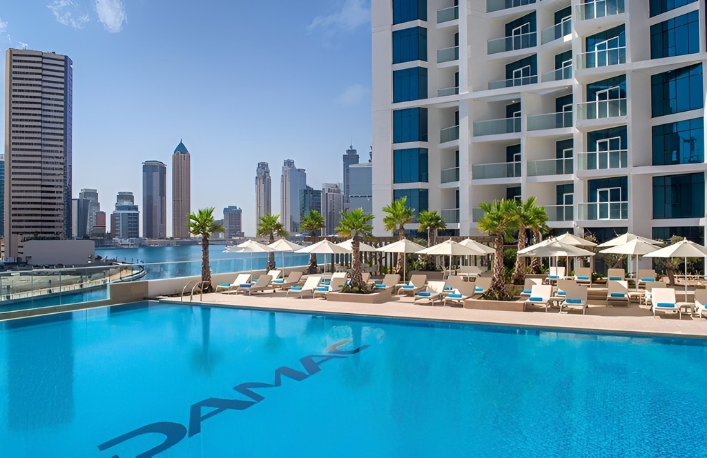 Aerial view of Damac Maison Prive, highlighting its modern architecture and prime location along the waterfront.