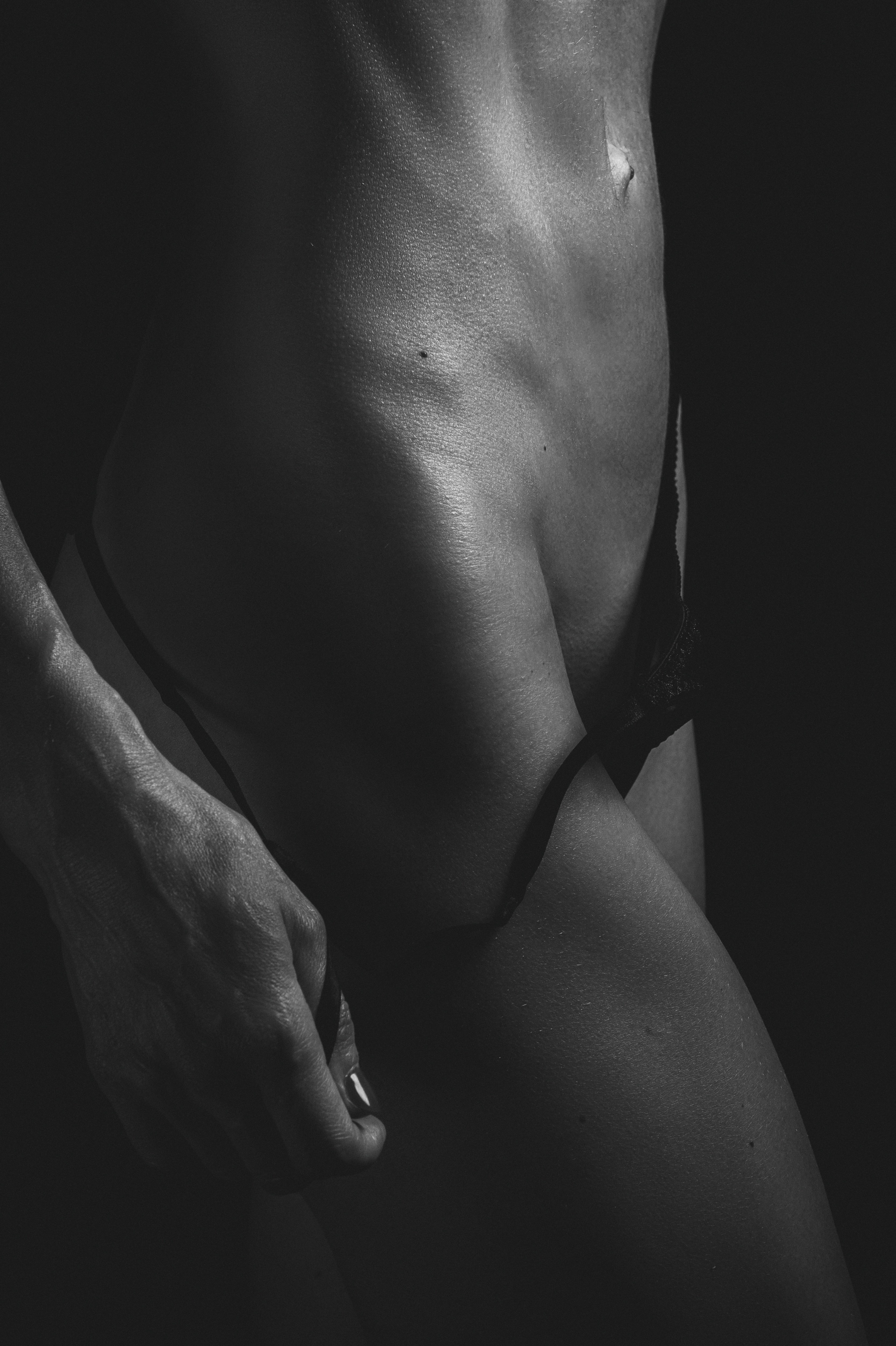 grayscale photo of woman in black brassiere