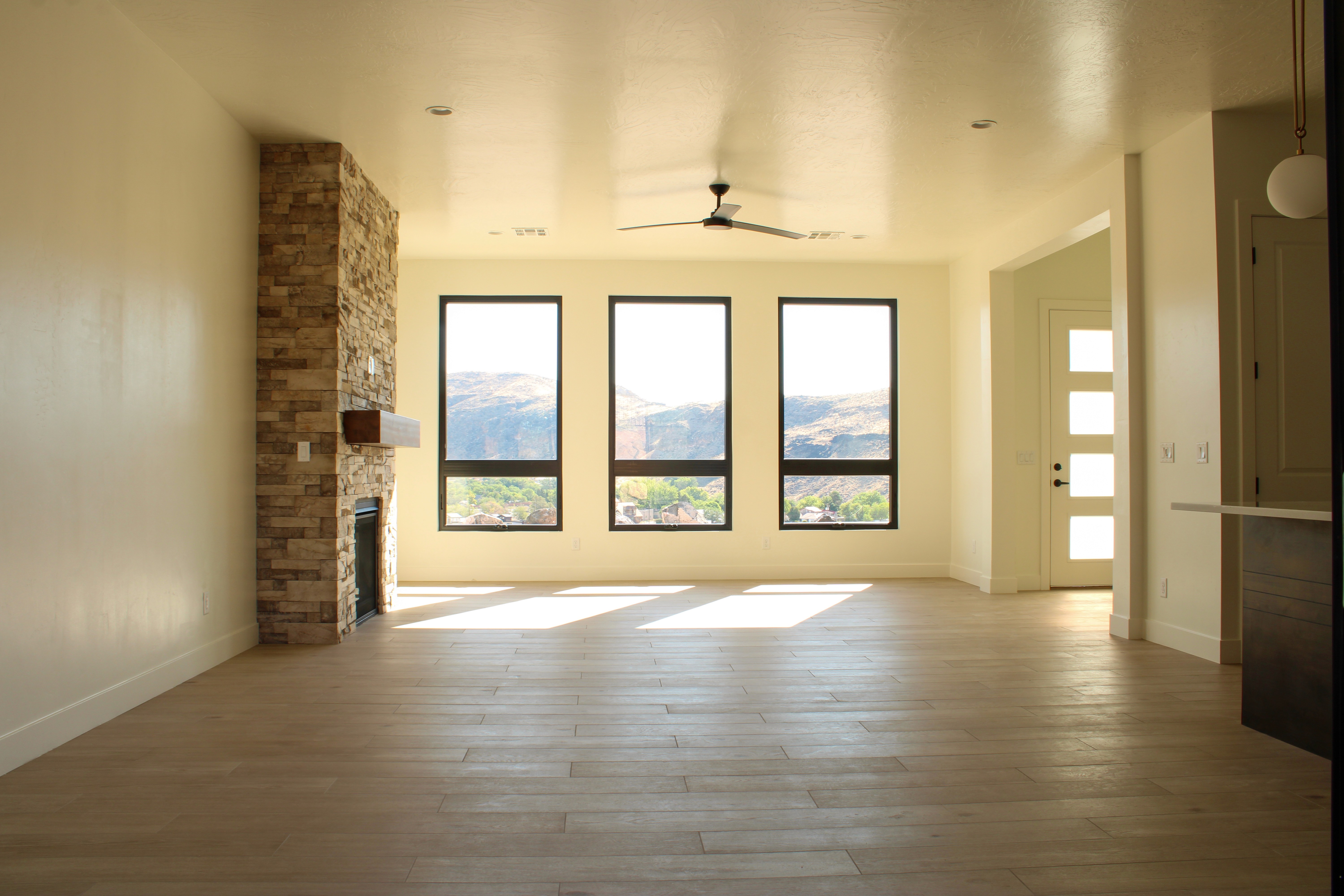 Living room of The Overlook at Falcon Ridge in Hurricane, Utah, with large windows and views of the valley.