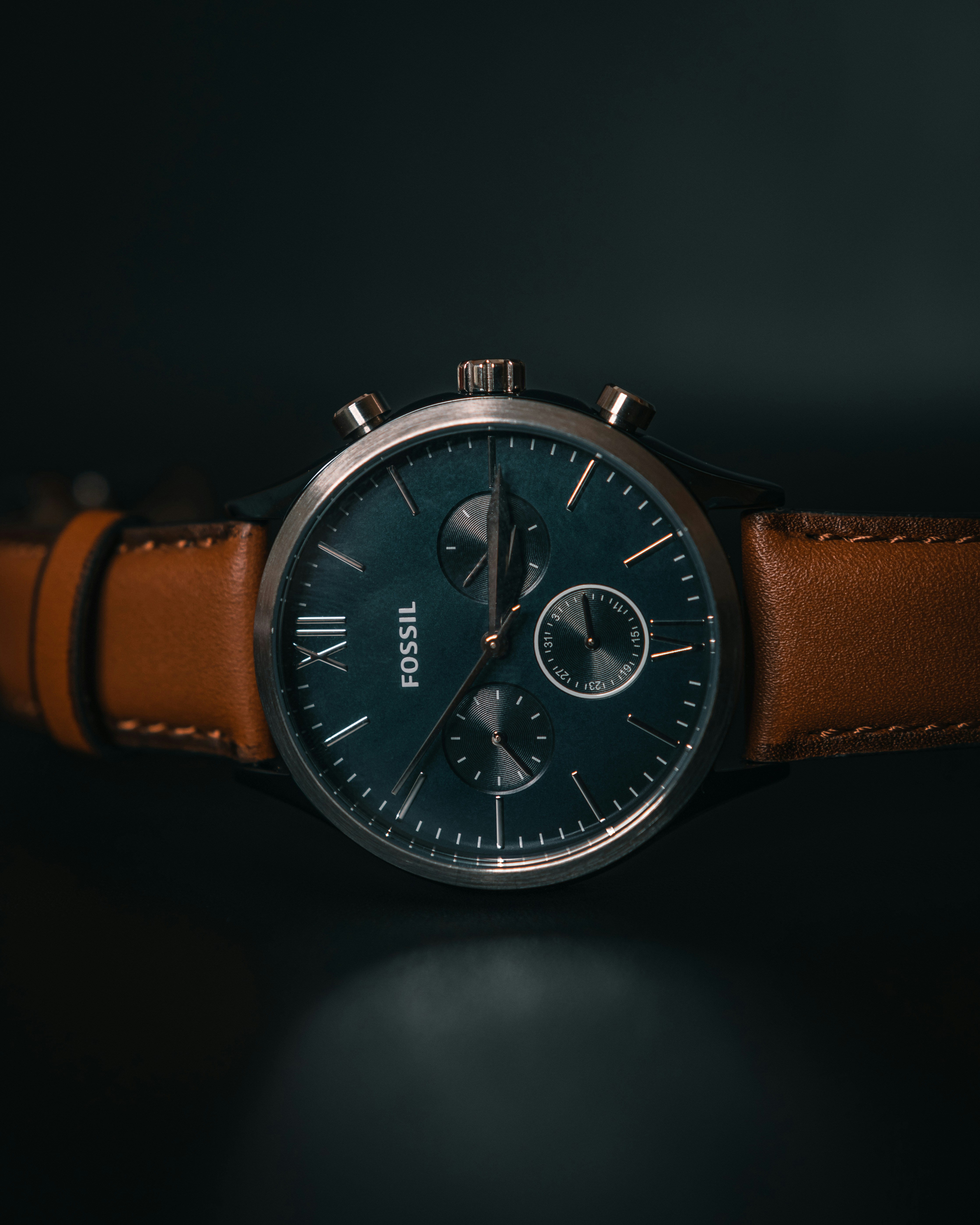 a close up of a watch on a black surface