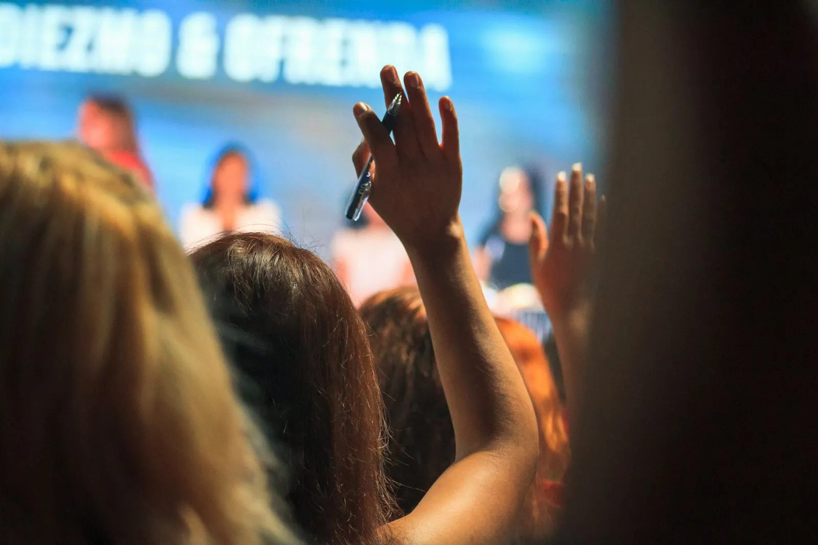 Residents raising hands at a public information session