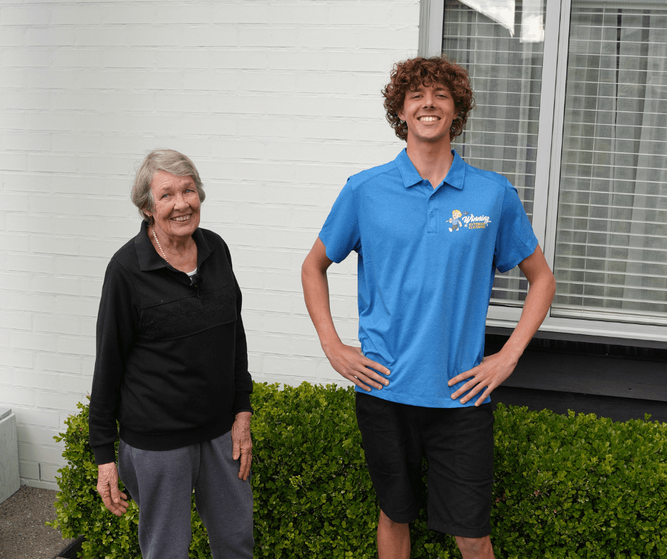Asher standing with happy customer after completing residential window cleaning service