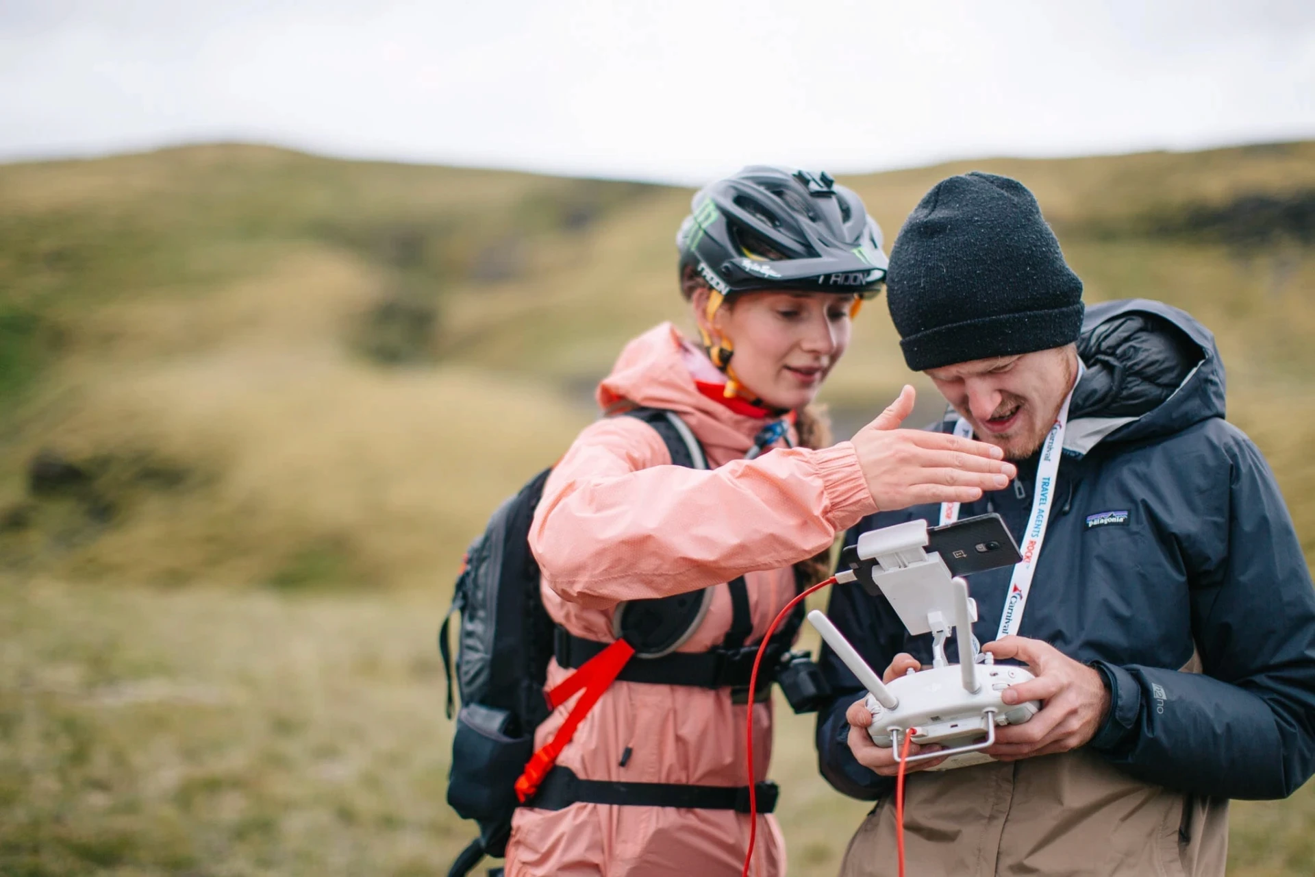 Two people controlling drone