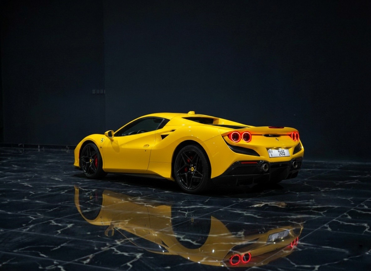 Yellow Ferrari F8 Spider 2023 rear left exterior, luxury supercar rental by Queen of Supercar Rental in Dubai