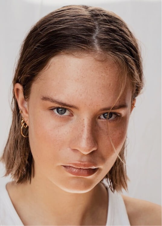 Close-up portrait with neutral expression and light hair