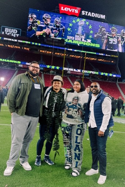 Al Beglinger and Henry Organ with a Seattle Seahawks client and family after the Super Bowl