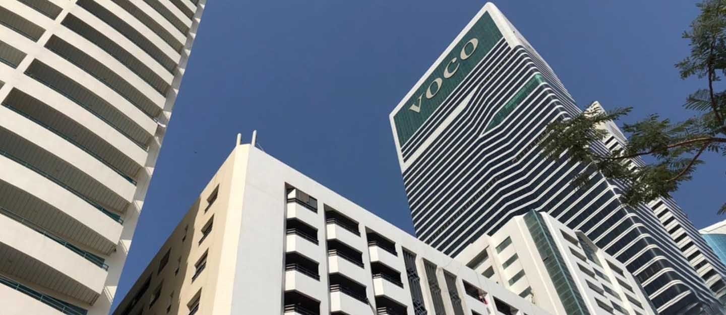 Modern architectural view of the White Swan Building adjacent to Voco Hotel in a prime business district.