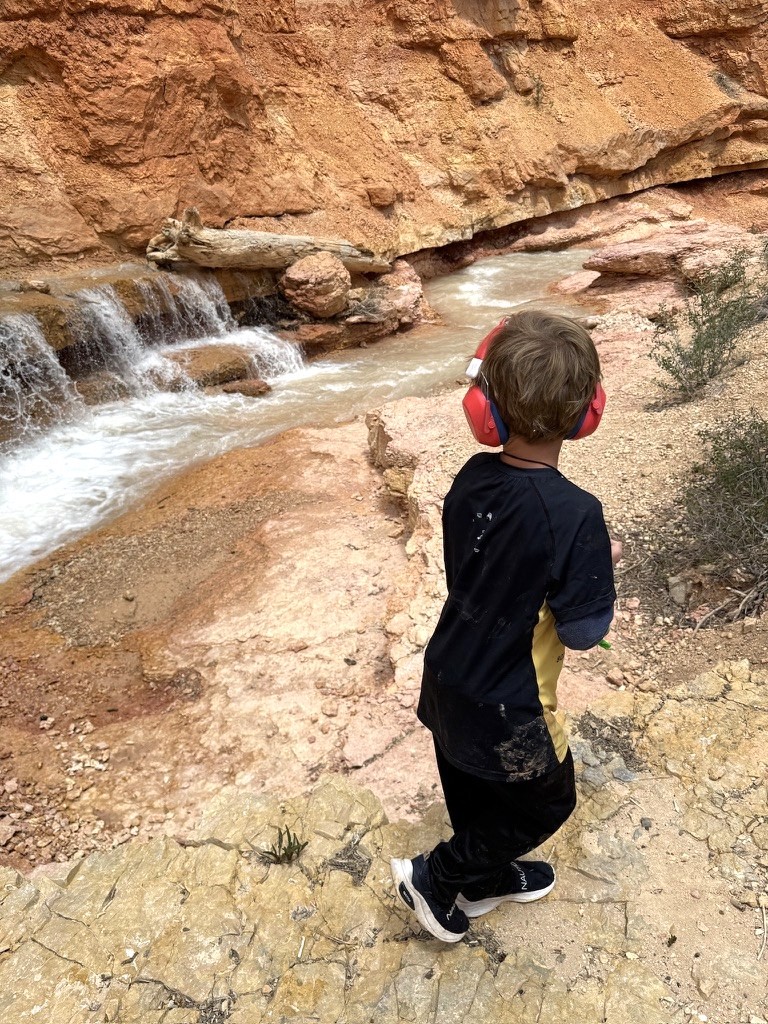 Hyrum wading in a creek along one of the water hikes near Bryce Canyon