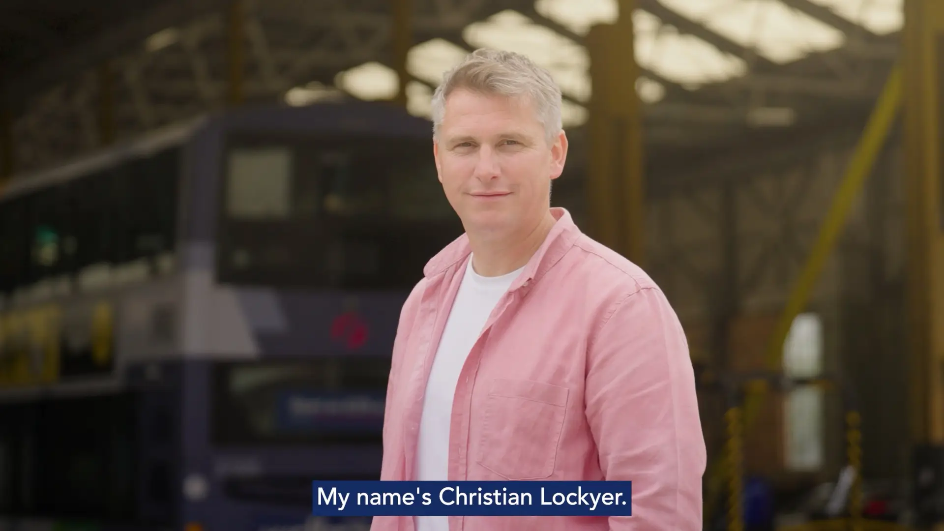 Group of presenters speaking on camera during a Microsoft live broadcast, filmed against branded event graphics.