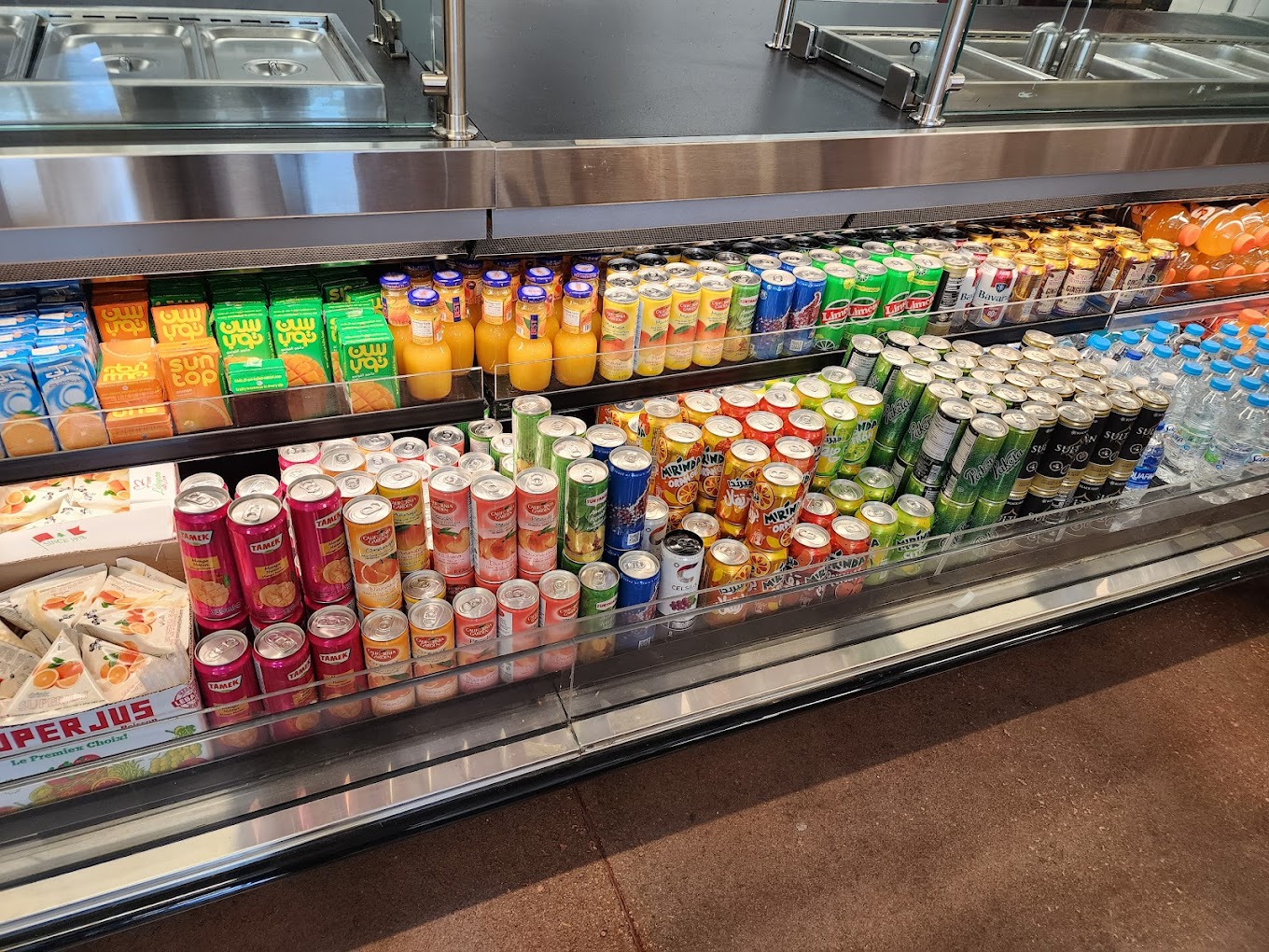 Chilled beverages and juices in the refrigerated section at International Food Market Orlando, featuring a variety of popular drinks from around the world.