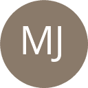 a man with a goatee smiles at the camera