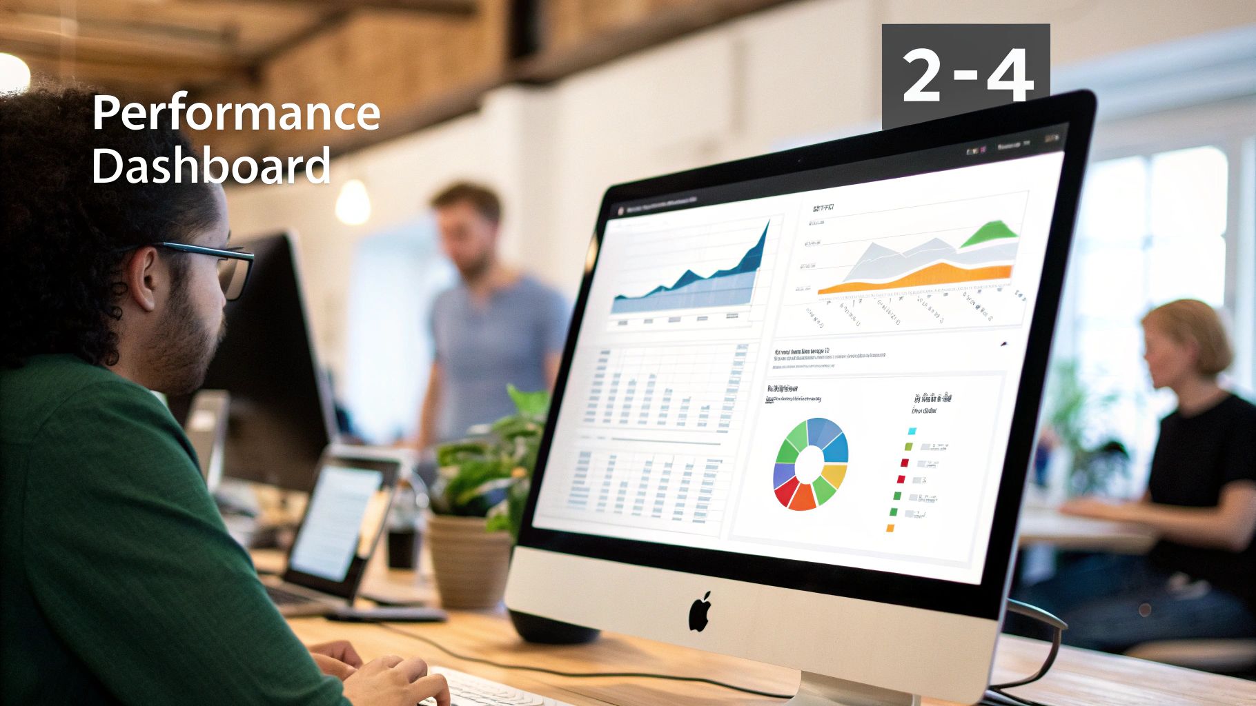 A person wearing glasses looks at an Apple iMac displaying a detailed performance dashboard with charts and graphs.