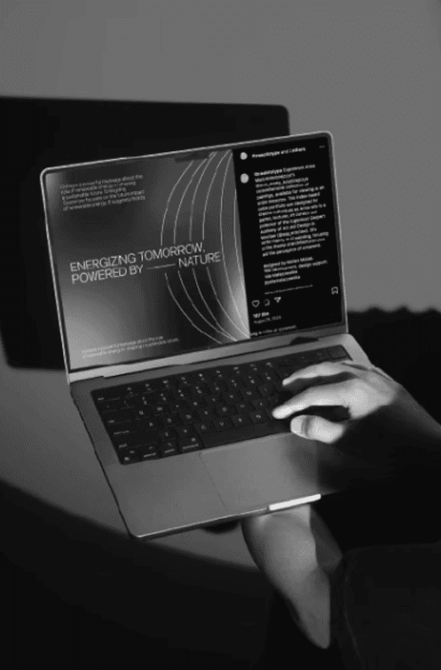 Black and white low-angle photograph of a person in a suit sitting on a chair, holding a sign that reads 'THINK BIGGER.' Concept for business growth, leadership, and professional mindset.