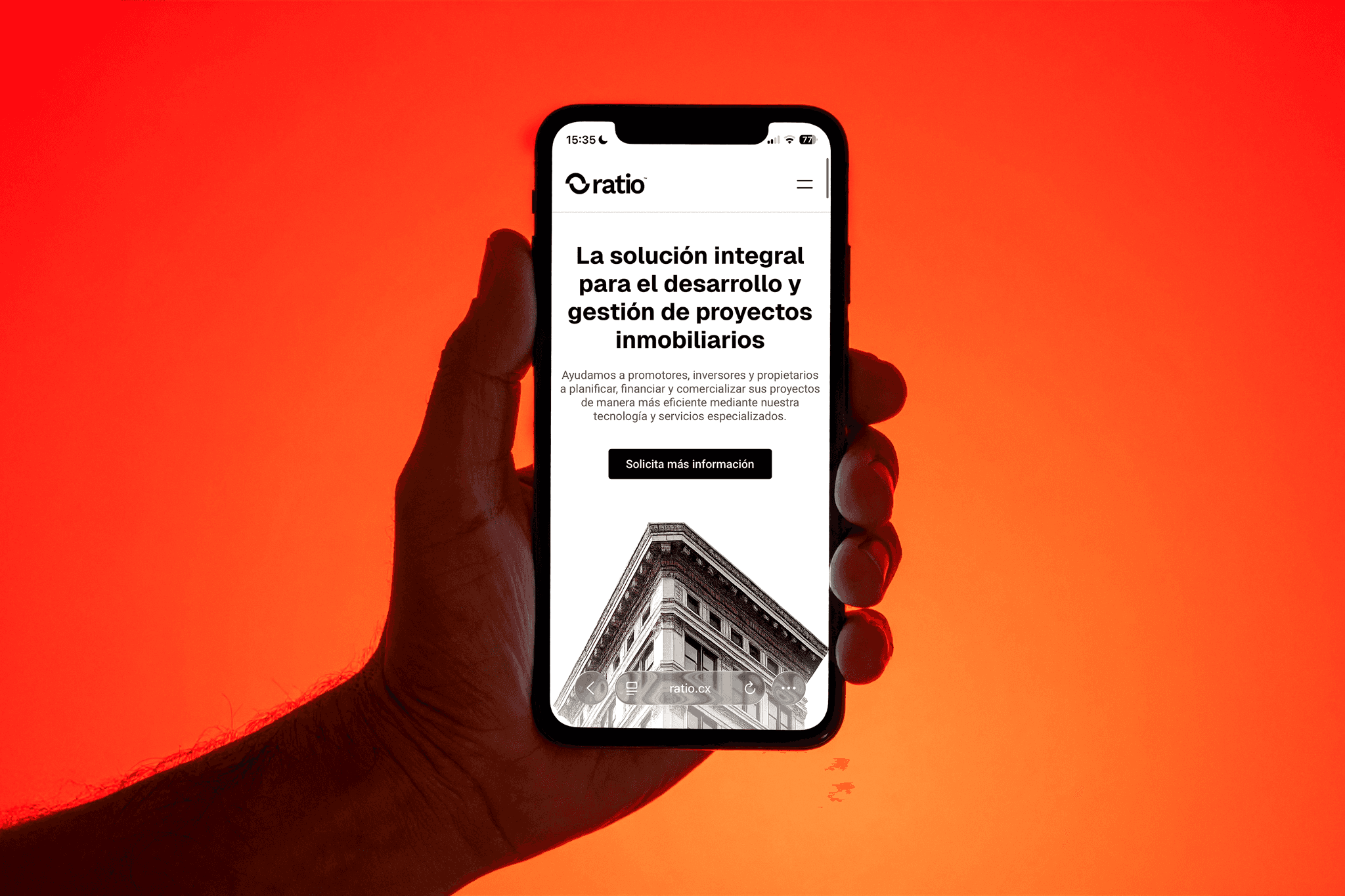 Hand holding smartphone showing the Ratio website interface with bold typography and minimal layout on a vibrant red background