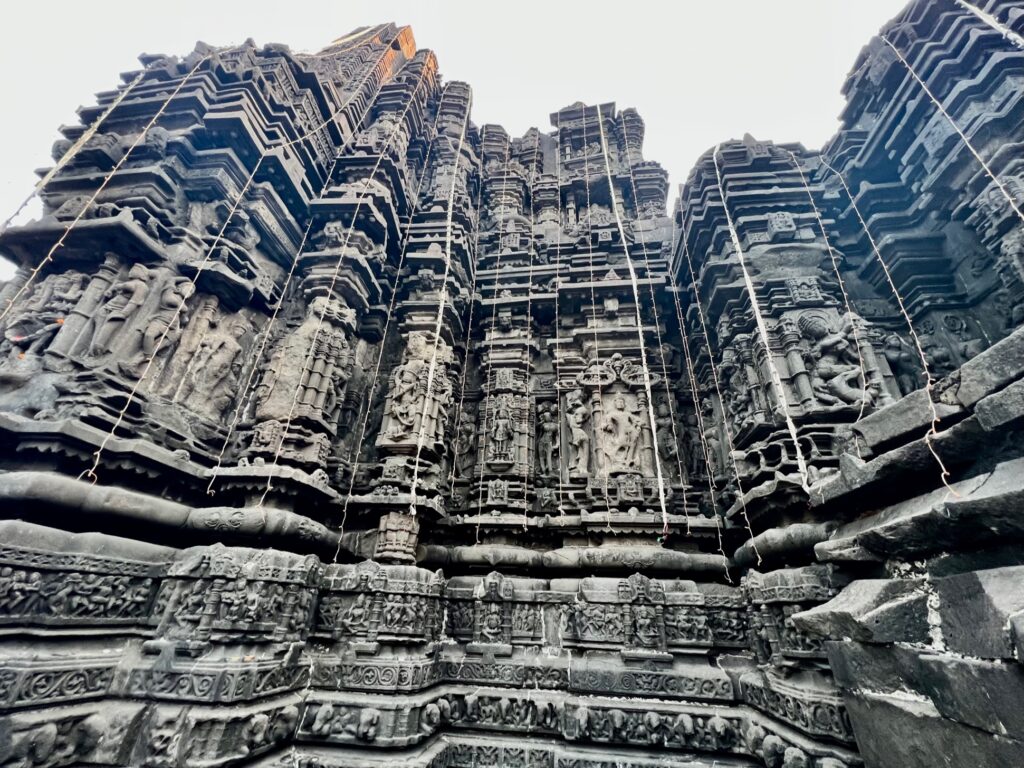 The intricate carvings of the Hindu pantheon on the exterior walls of the temple.