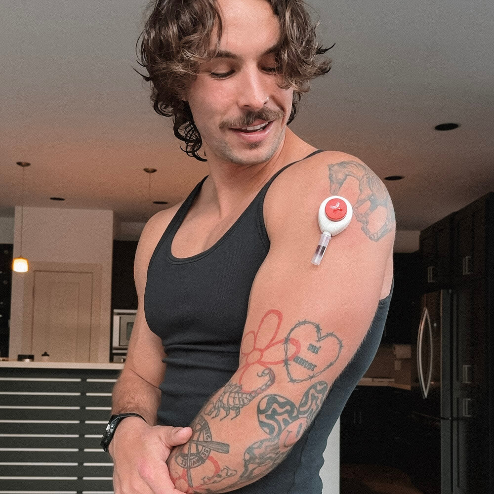 Diplo doing the rythm health at home blood test smiling.