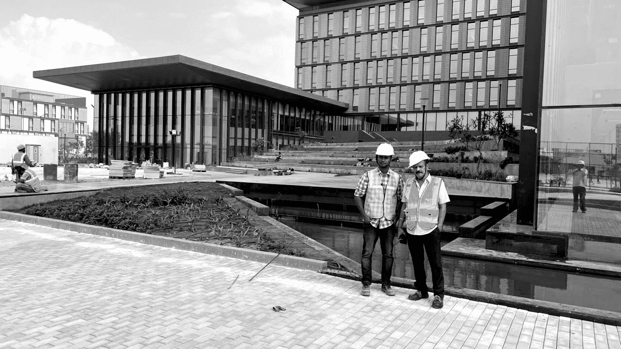 Two men standing with Luxury water features in the background