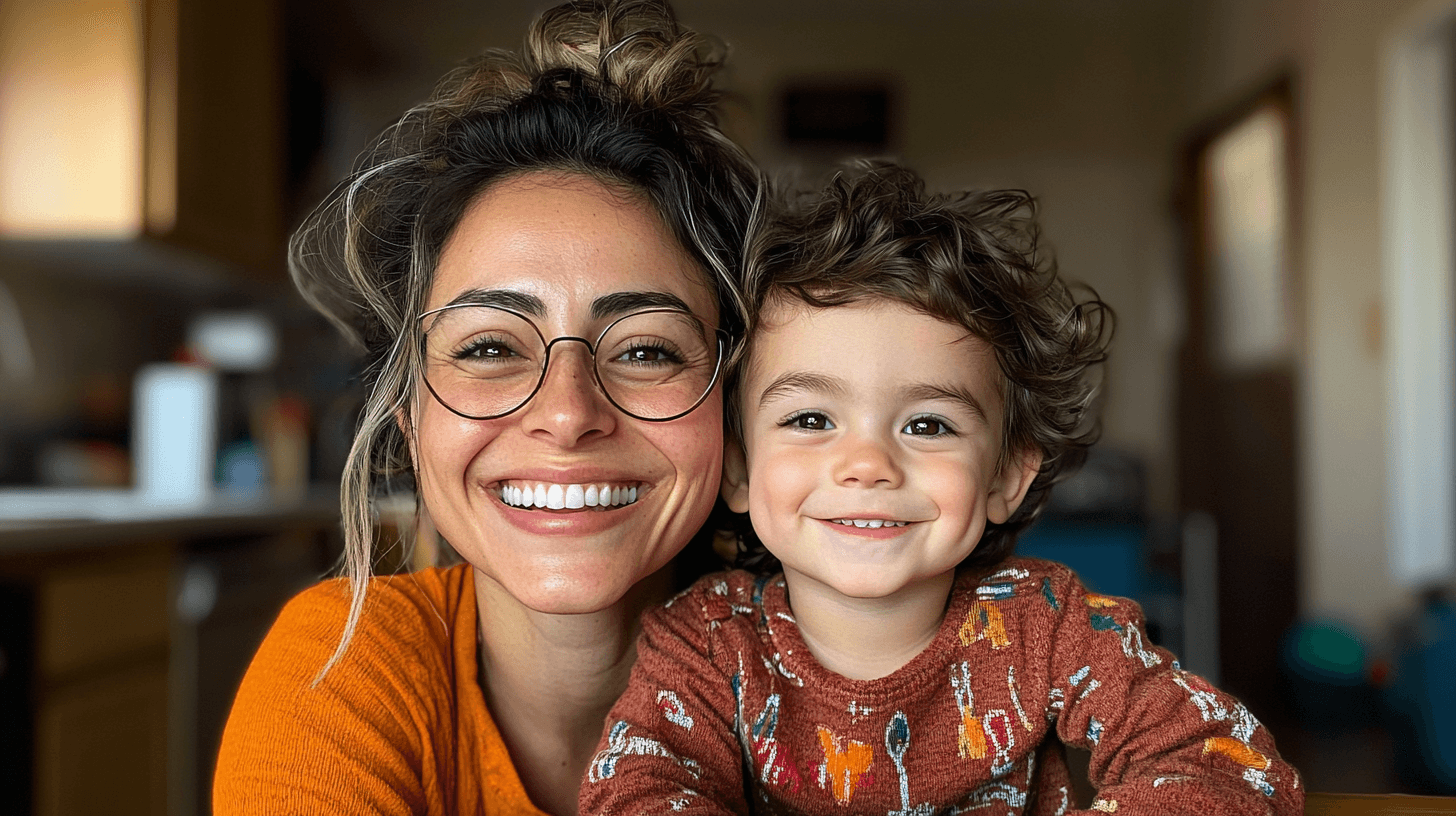 A joyful nanny and child laughing together on a colorful couch, showcasing the flexibility and connection part-time care provides.