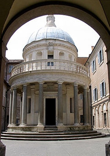 A photo of a circular shaped building with stone pillars around it.