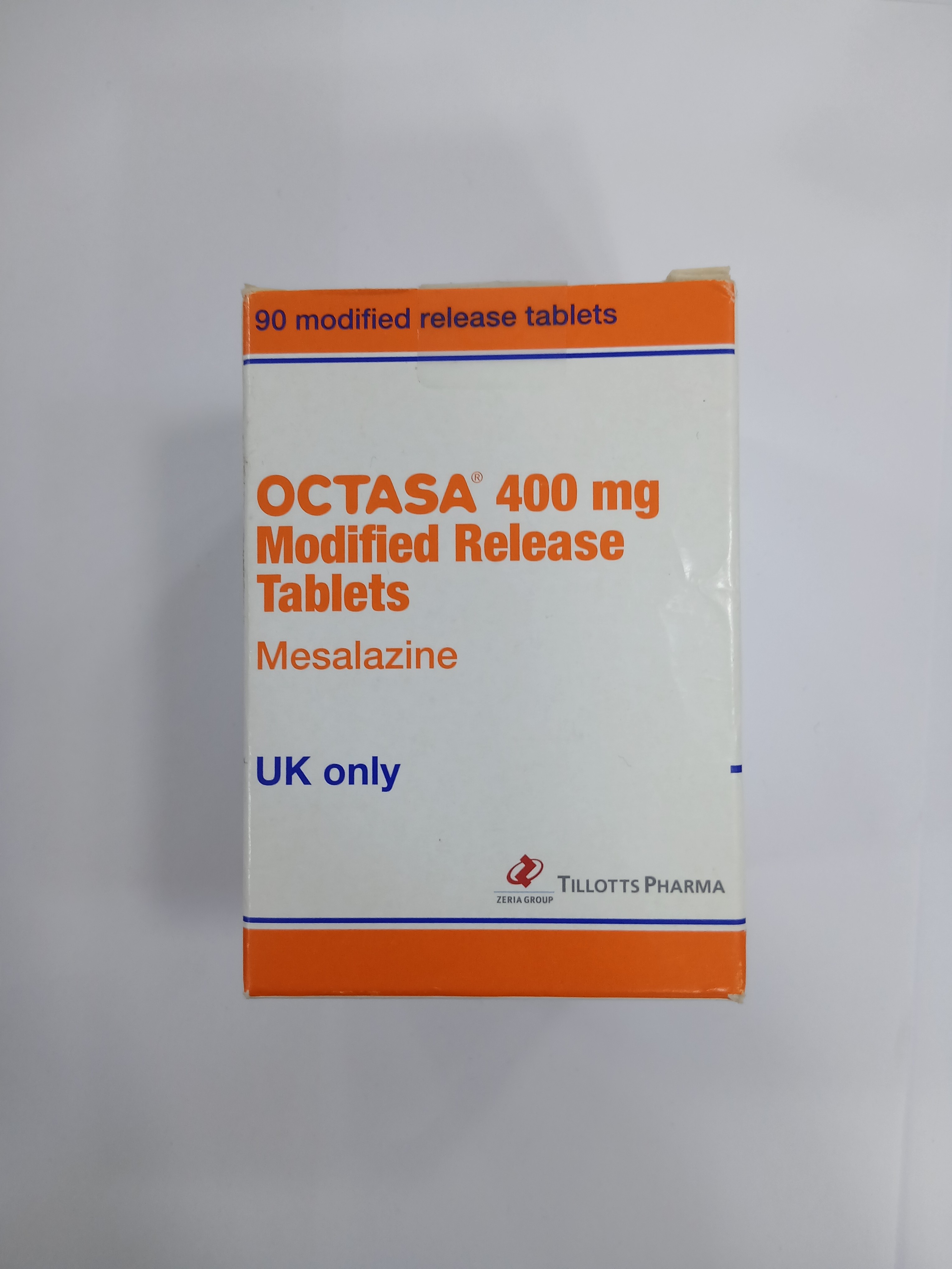 White and orange cardboard box packaging for modified release tablets, labeled with black and orange text indicating 90 tablets, 400 mg dosage, and UK-only distribution.