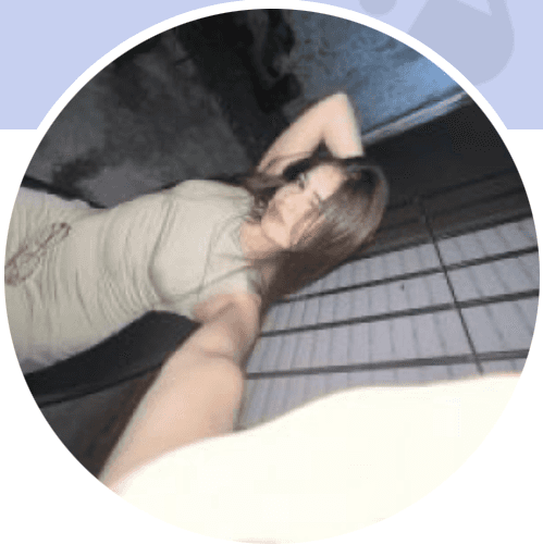 A Young woman in grey blueish background smiling