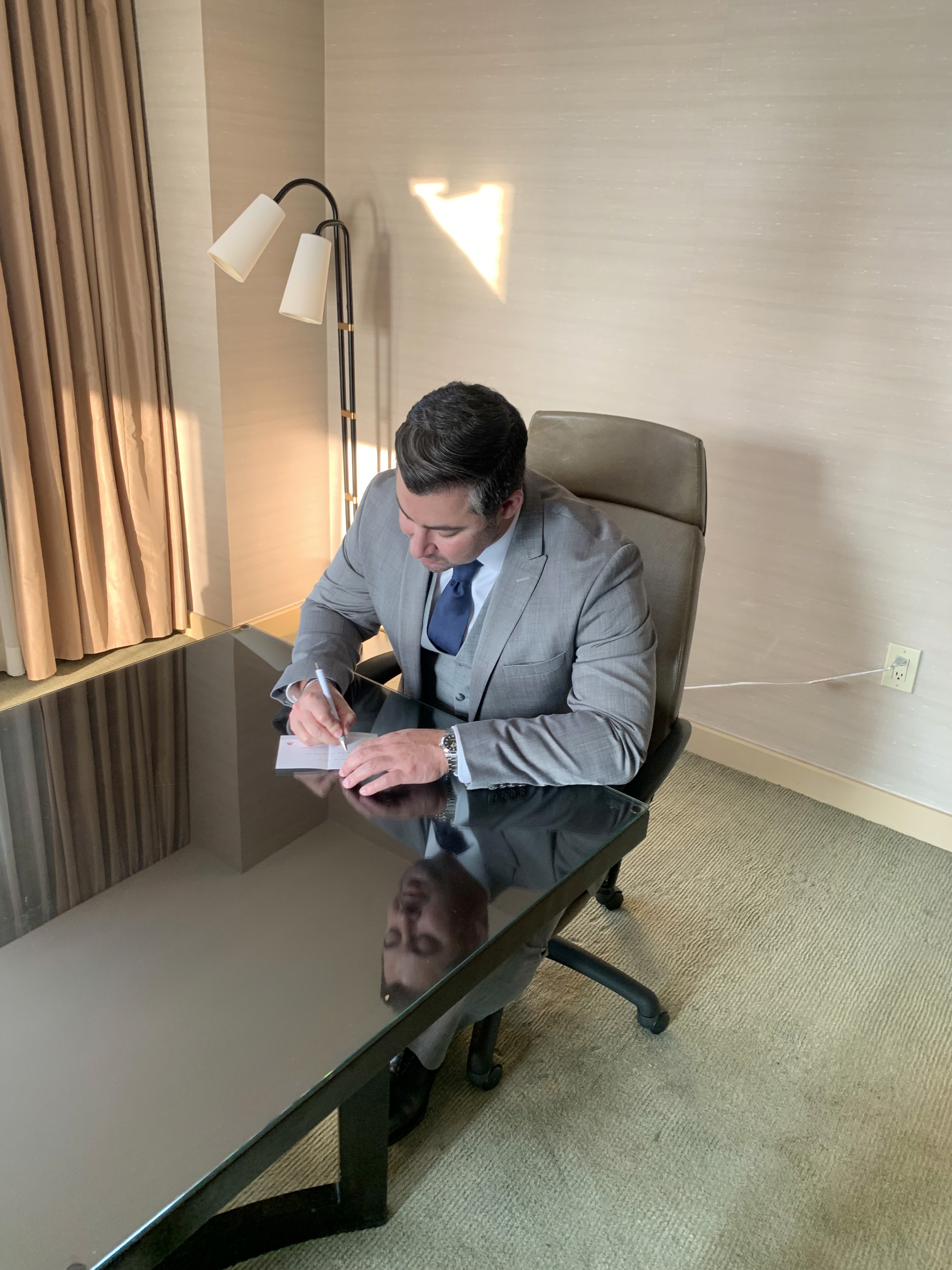 John Reichert taking notes at a desk