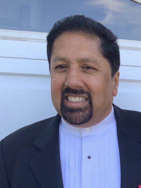 woman in black crew neck t-shirt wearing brown framed eyeglasses standing on rocky shore during