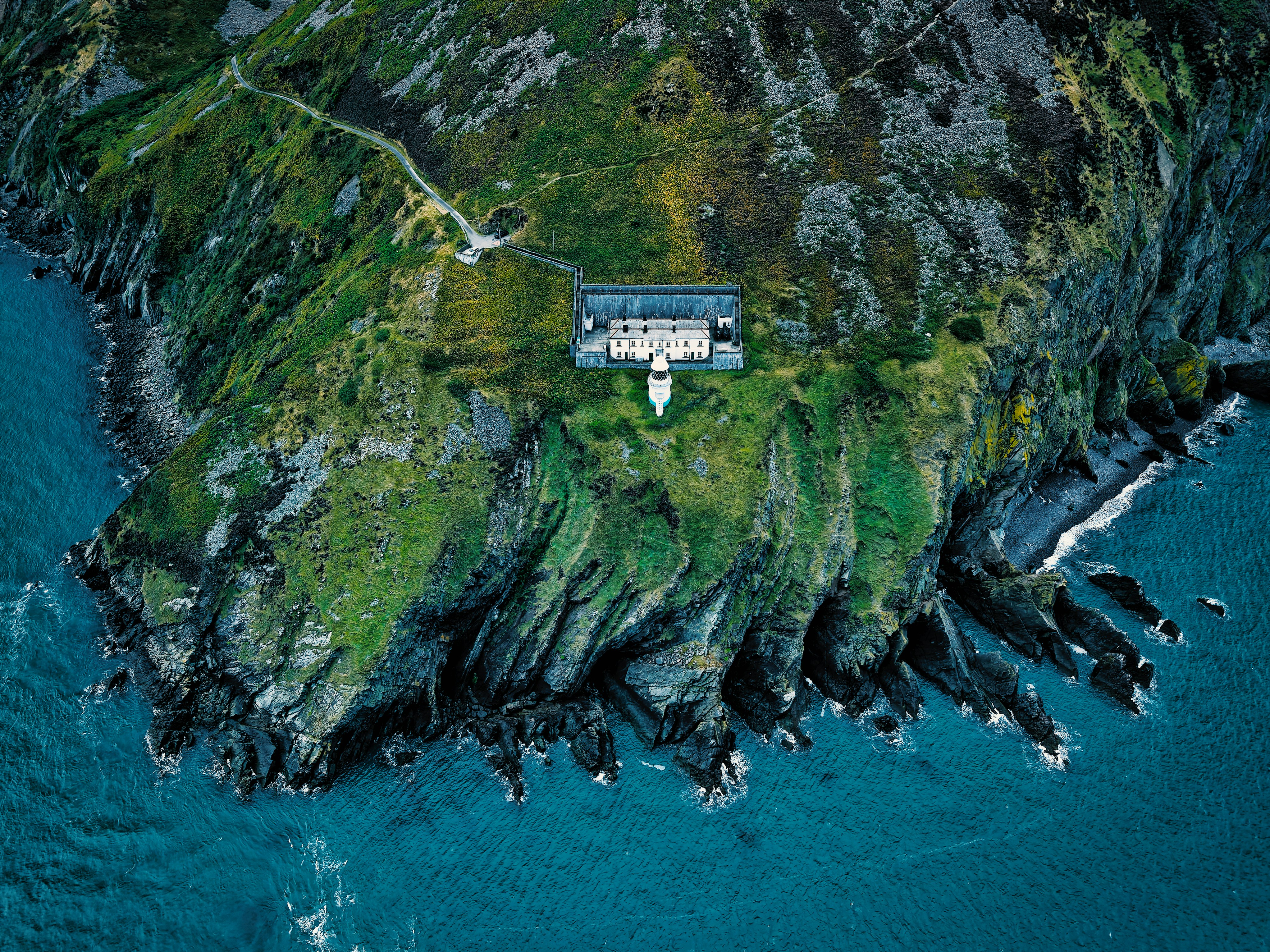 Remote house on a green, rocky island by the sea