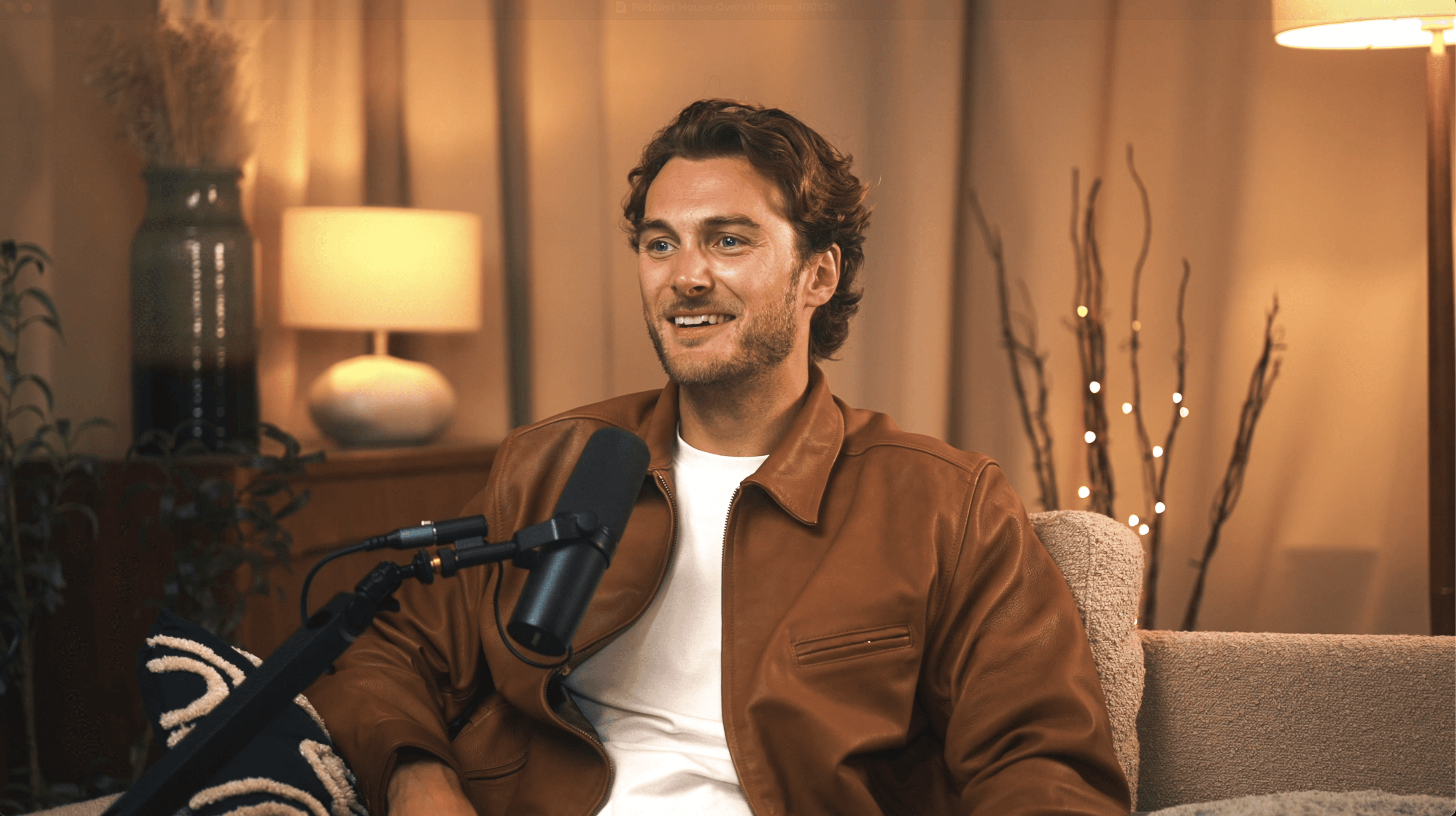 Male podcast guest speaking into microphone in professional podcast studio setup”