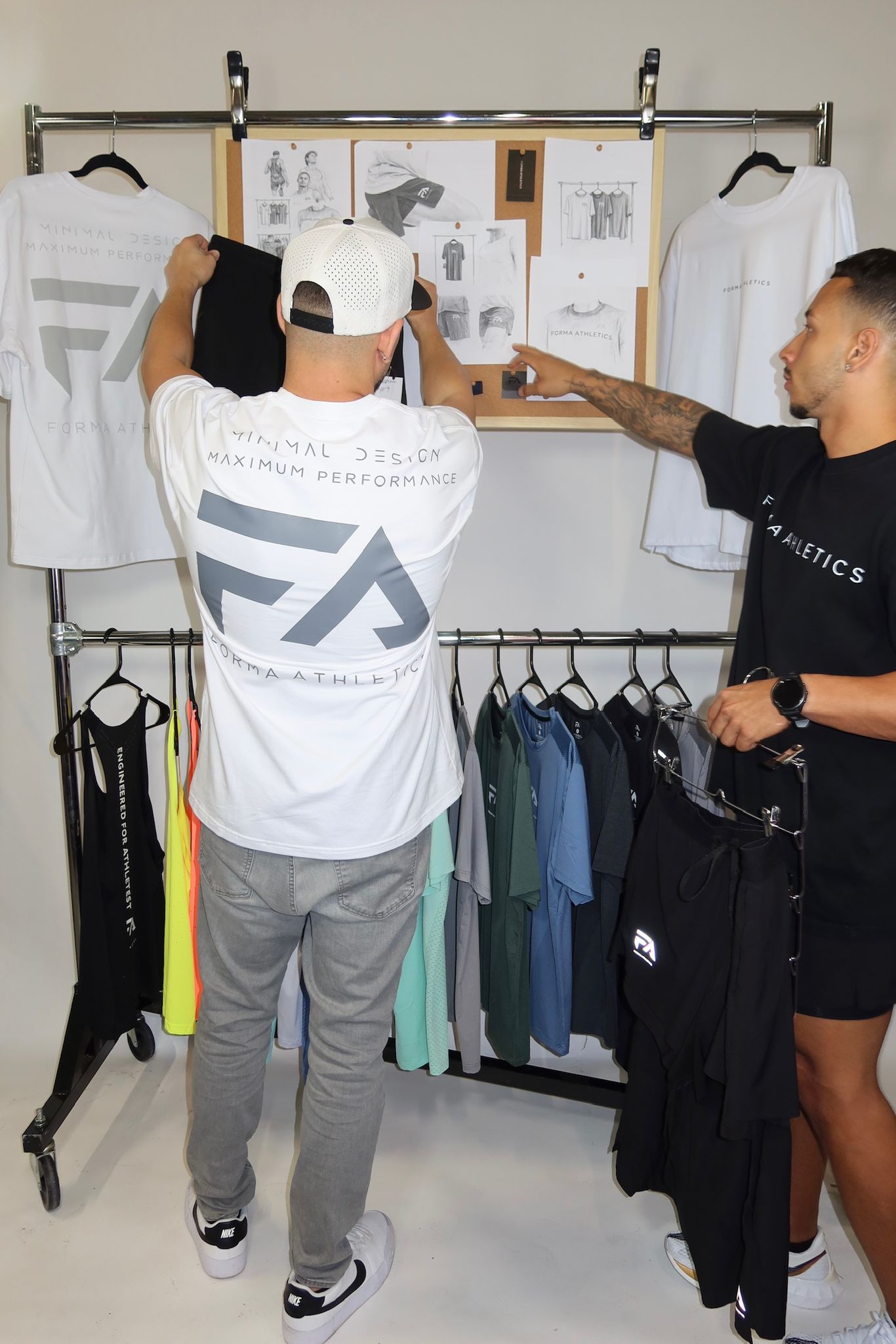 An image of the two founders of Forma Athletics reviewing ideas and clothing samples