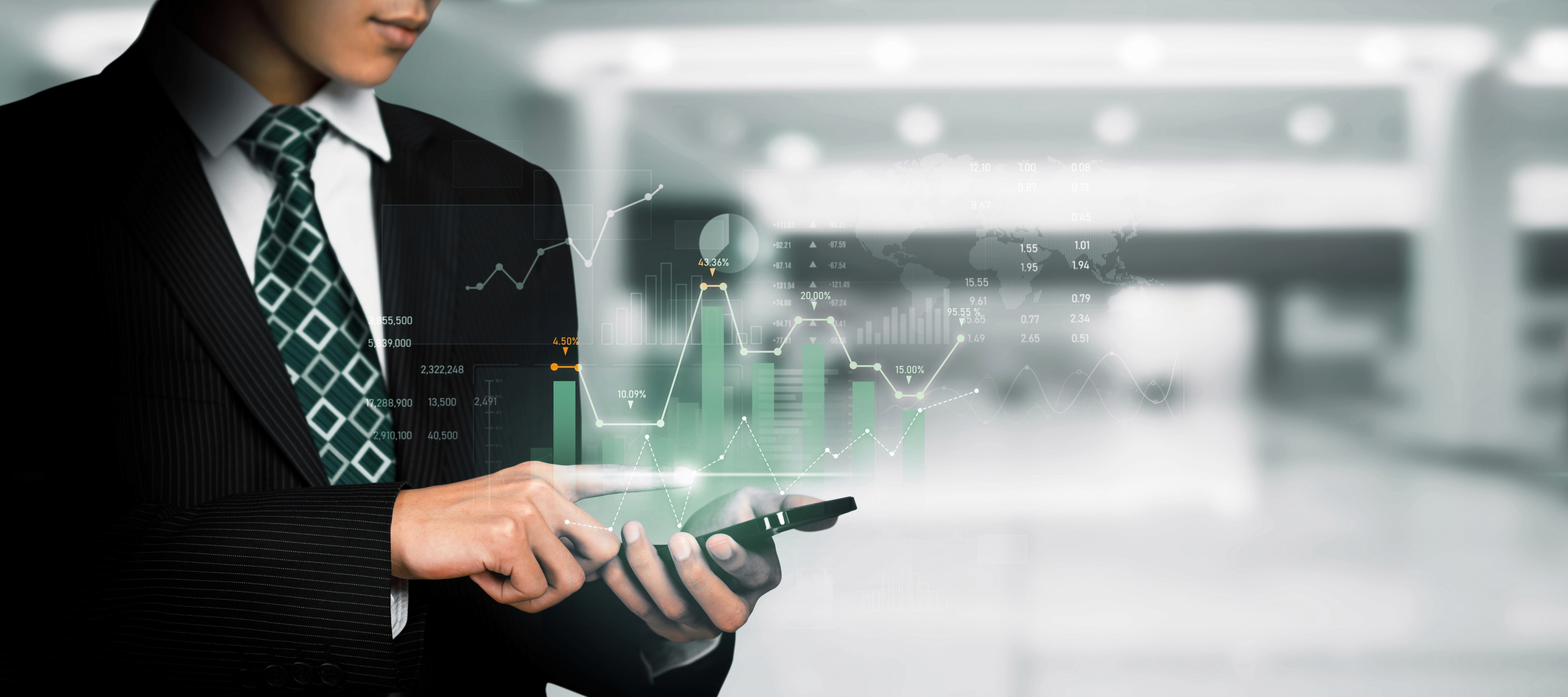 a group of people sitting around a table with laptops