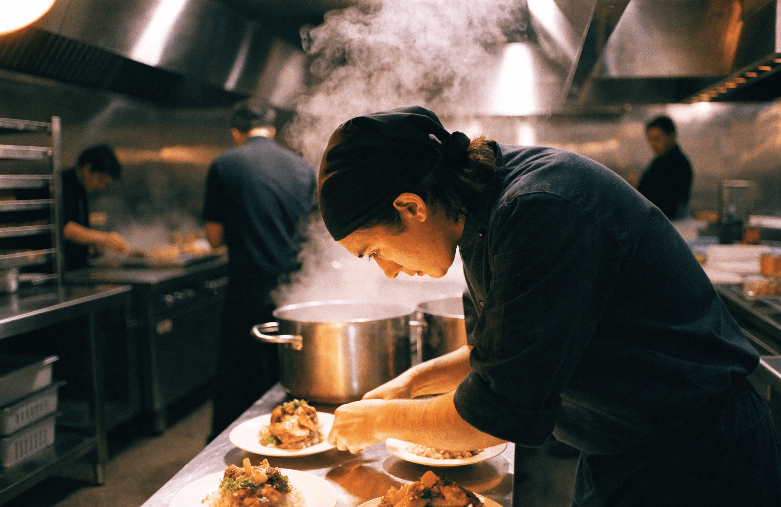 Chef plating dishes during a busy restaurant service