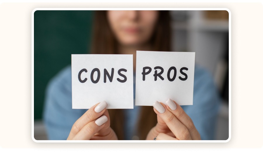 Person holding cards labeled pros and cons
