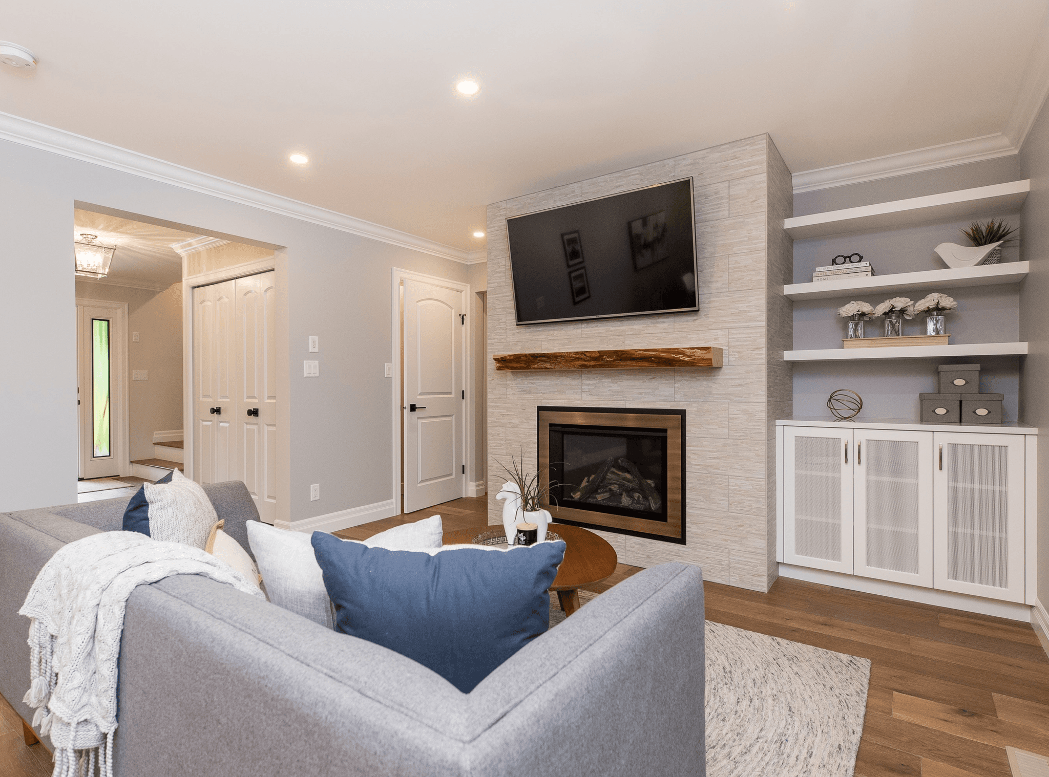 Living room with built-in shelving and wall-mounted TV.