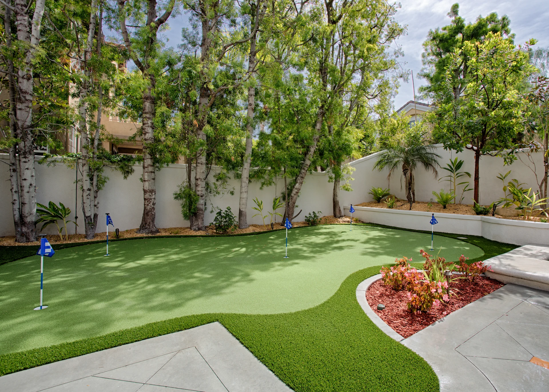 View of the backyard putting green, a fun and luxurious addition to the outdoor living space in this Newport Beach home.