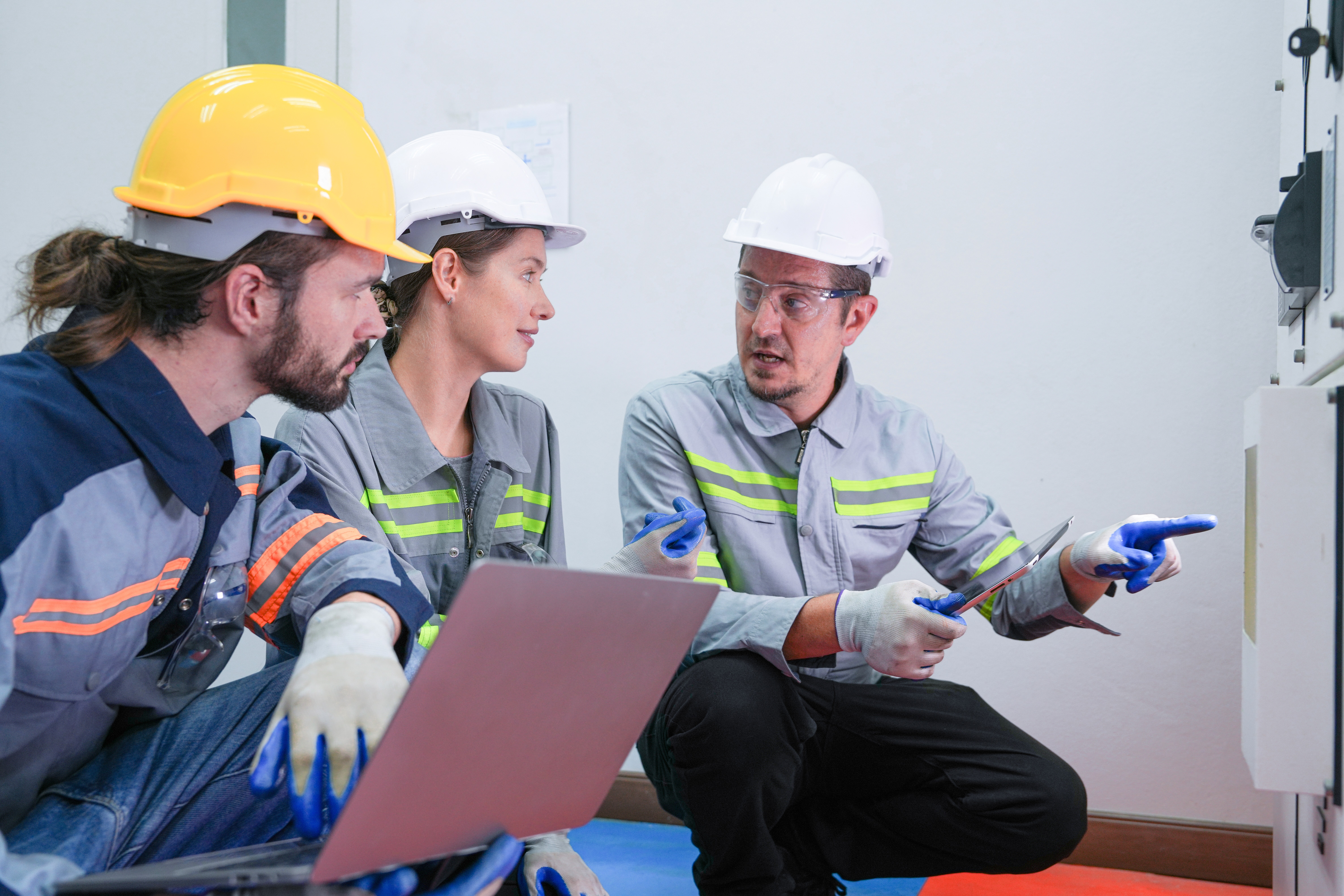 a man working on a pipe in a cabinet
