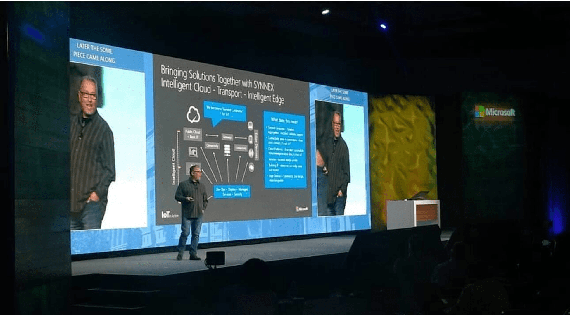 Rob Moyer presenting "Bringing Solutions Together with SYNNEX Intelligent Cloud - Transport - Intelligent Edge" on large conference stage with technical architecture diagram