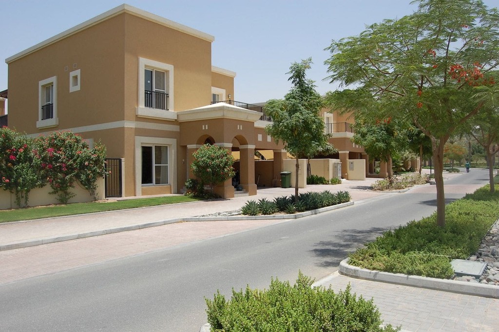 Two houses nestled in a lush green area, showcasing the beauty of Semmer Villas.