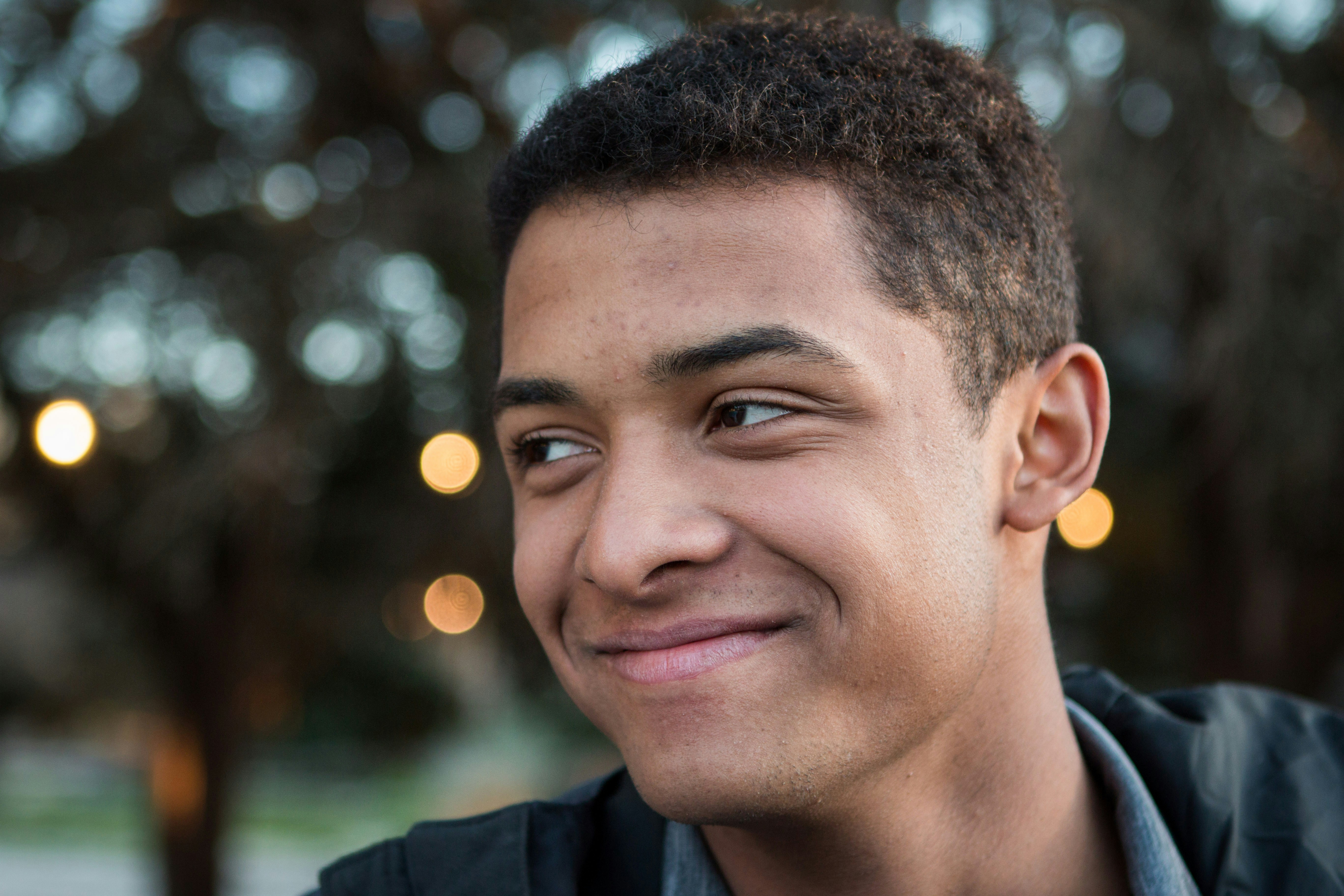 man in black collared shirt smiling