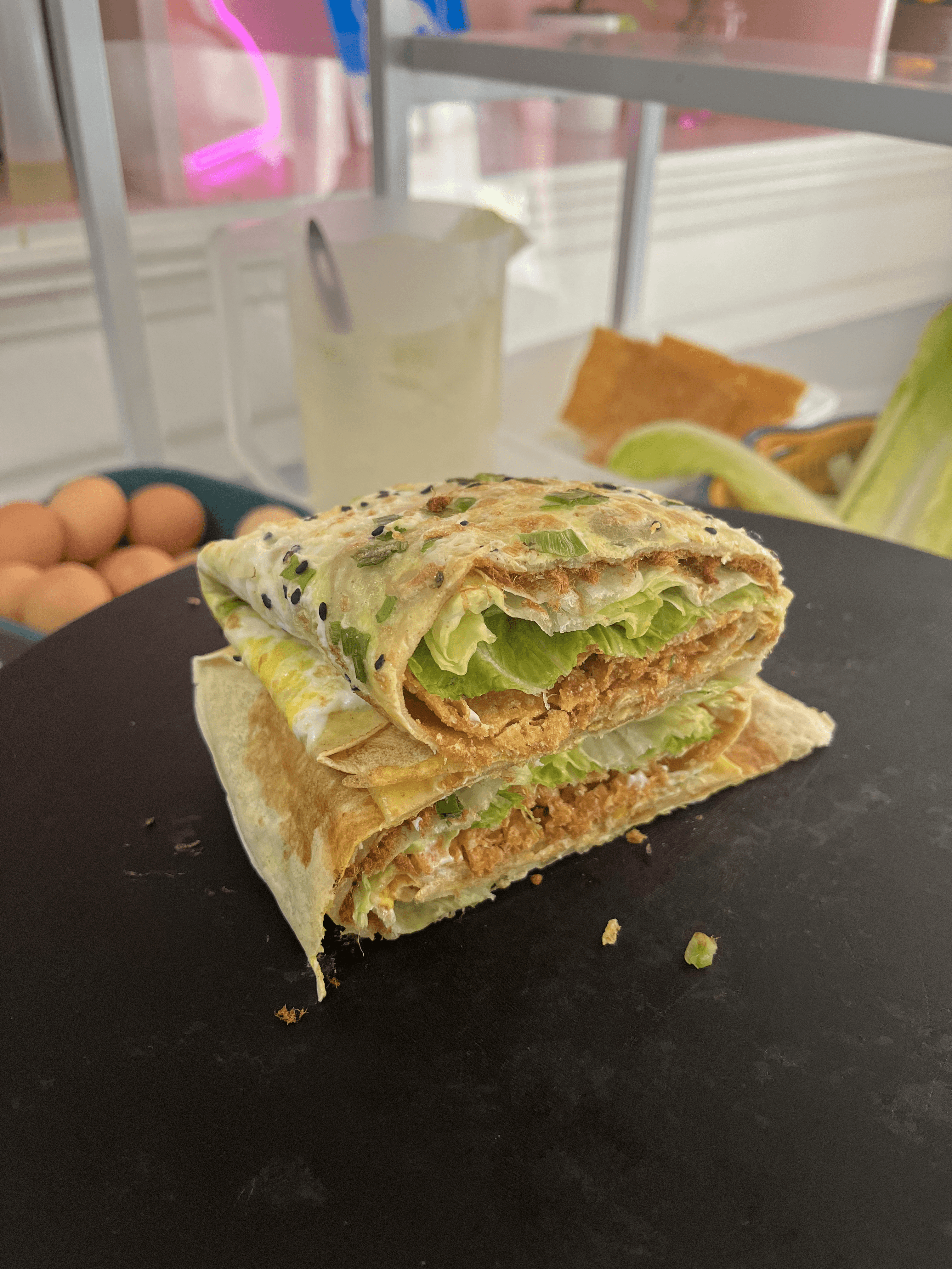 Close-up of Pink Cloud Tea’s vegetarian Jianbing wrap, featuring crispy tofu, egg, and spicy seasoning, perfect for a grab-and-go meal in Berkeley.